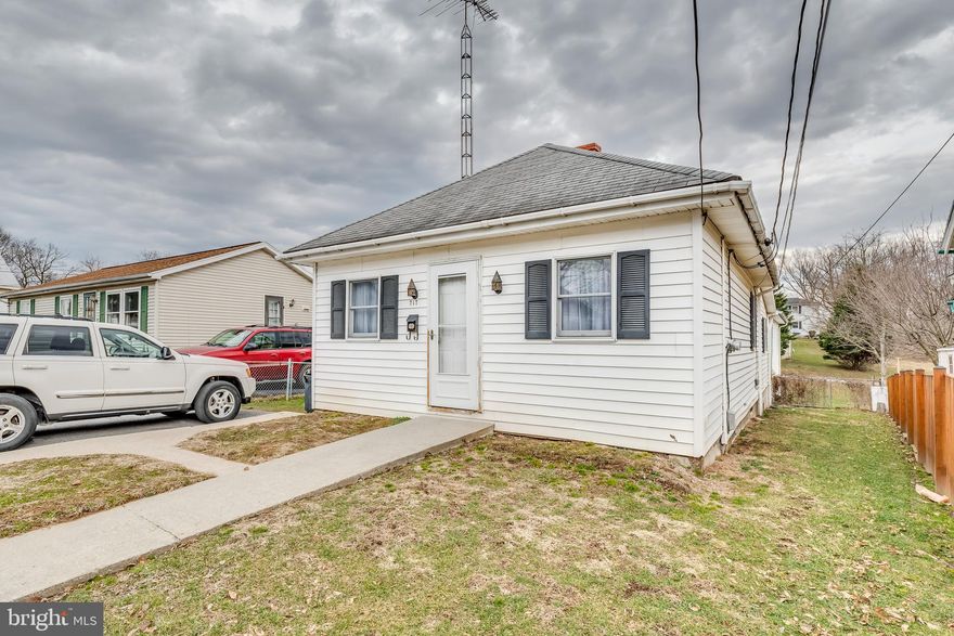 Clean & comfy little bungalow that's been upgraded and modernized. Freshly painted, newer roof and move in ready. There's a huge detached garage and roomy finished area above (area is carpeted, dry wall & paneling is installed--need to add water & heat to make a very nice second living area. Large lot - partially fenced.  Off street parking.  Good condition.