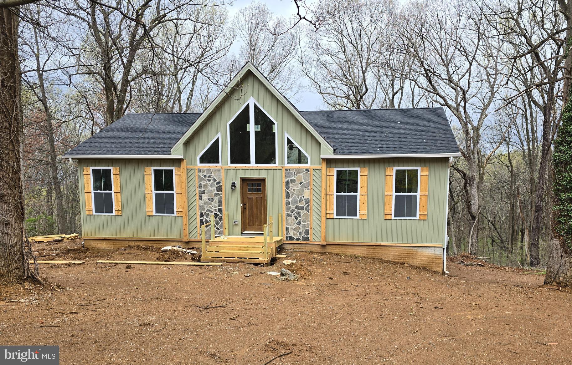 To Be Built. Construction will begin once a contract is accepted. This Brand new "Mountain Style Rancher" nestled on .53+/- acre . The outside features "Cyprus" color siding , partial stone front, cedar shutters, cedar front door,, architectural shingles, and boasts a large gable window that allows plenty of natural light. 3 bedroom 2 bathrooms, stainless steel, farm sink, stainless steel appliances, live edge on top of kitchen island, granite countertops, natural tone luxury vinyl plank flooring through out the whole house, white oak beams across the vaulted ceilings, unfinished basement with rough in plumbing as well as 9 foot ceilings. . Built in book case in the primary bedroom and the primary bathroom has custom shelving. Two tier deck provides limitless opportunities to watch and connect with nature and the beauty of your private setting. This amazing property borders West Virginia Public land consisting of over 23 acres and direct access to the Shenandoah River. Hiking, fishing and more is what you can take advantage of in the vicinity 120 day delivery once foundation has started. Pictures are similar construction.
