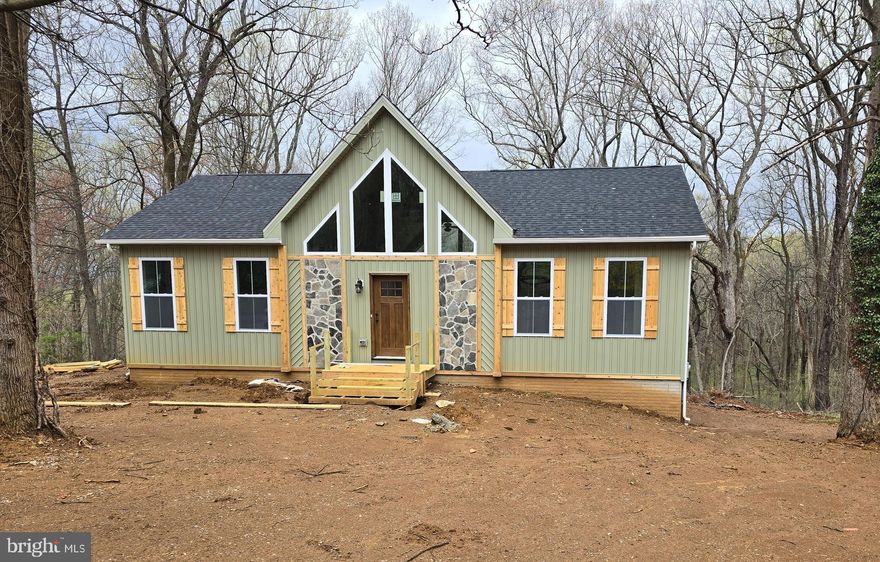 To Be Built. Construction will begin once a contract is accepted. This Brand new  "Mountain Style Rancher" nestled on .53+/- acre . The outside features "Cyprus" color siding , partial stone front, cedar shutters, cedar front door,, architectural shingles, and  boasts  a large gable window that allows plenty of natural light.  3 bedroom 2 bathrooms, stainless steel, farm sink, stainless steel appliances, live edge on top of kitchen island, granite countertops, natural tone luxury vinyl plank flooring through out the whole house, white oak beams across the vaulted ceilings, unfinished basement with rough in plumbing as well as 9 foot ceilings. . Built in book case in the primary bedroom and the primary bathroom has custom shelving. Two tier deck provides limitless opportunities to watch and connect with nature and the beauty of your private setting. This amazing property borders West Virginia Public land consisting of over 23 acres and direct access to the Shenandoah River. Hiking, fishing  and more is what  you can take advantage of in the vicinity 120 day delivery once foundation has started. Pictures are similar construction.