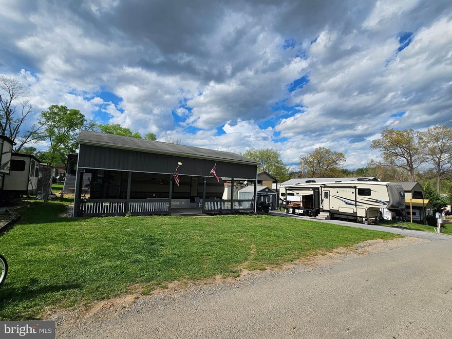 Block 6 Lots 15 & 16 are it! Just the lots you've been waiting for. Immaculate. 
Welcome to Block 5 lots 15 & 16 Poison Oak sitting on a flat double lot in Riverbends Rv Campground. Riverbend is 400 Acres of SEASONAL recreational campground full of amenities located on the Potomac River in Falling Waters, Wv. OPEN APRIL 1 - NOVEMBER 1 - This is a fun & entertaining community, yet relaxing. 
Conveying with these lots are 2 campers one is a 32 Ft 2019 Forrest River Wildwood in excellent condition and a 34 Ft 2014 LARGE Crossroads 5th wheel Sunset Trail with so much space; it will wow you. Also conveying is a 2023 Electric 48 Volt Ezgo Rxv Vallor Golf Cart. 

The Forrest River Camper is housed under a massive pavilion with gutters and downspouts, completely wired with electric outlets and 3 new 54 In ceiling fans that connect to bluetooth to control the speed of the fans and changing light colors via phone. This all sits on a nice est 40 * 20 Ft concrete pad. Inside the camper you'll notice all the upgrades including counters, faucets, and a Mini Split unit to keep you HOT sleepers extra cool. The main bedroom is a Queen size, it has 3 closet spaces and comes with a Dyson vacuum. This bedroom has it's own entry door as well. In the main area, you'll find a sofa that pulls out for extra sleeping, 2 recliners, a Vizio TV, Furrion surround speakers and electric Fireplace. A step outside just sits you on such a spacious beautiful outdoor patio and all the Furniture conveys. Sit, relax and host your friends while enjoying the flat front yard for campfires, corn hole, or even extra parking. The Adjoing lot is paved, while it can fit 4 vehicles in a row it also hosts the very large 5th wheel camper that is perfect for you to have overnight guests. Check out the photos! This camper comes with an outdoor set up with a mini fridge, sink, hook up for a small propane grill. The inside Tv flips around to be enjoyed from the outside. Inside the ceilings are so tall and the Kitchen has more space than you typically see in a camper. The bedroom has its own entry to the bathroom. The 5th wheel also comes with an extra Black water 35 Gallon storage tank Really must see to appreciate. It's a beaut.  The shed has electric and comes with an ice cold fridge, washer and dryer. The roof was sealed in 2025.

Call today for your personal tour. Approx. 10 miles of Deep water on the Potomac River access for boating, fishing & swimming. Yearly membership ($1,987) plus a $200 initiation fee for new owners, includes water, sewer, electric, trash and the park amenities such as 3 pools, putt putt course, Horseshoe club, Boat club, Poker runs, Trick or Treat, Christmas in July, live bands, basketball court, tennis court, fireworks, car show, Church, restaurant, bar, convenience store (Great food), playground, volleyball, ball field and much much more. Join Riverbend Boat Club. Bring your golf carts, water toys and come enjoy life!