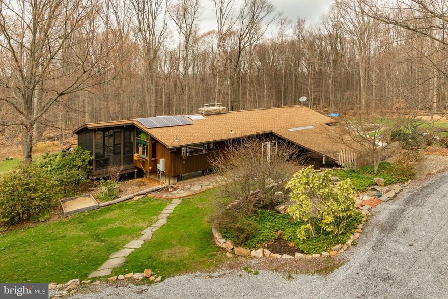 Secluded, mostly wooded, 13 Area place with spacious rancher w/over 2940 SF finished area.  Spacious eat-in kitchen, living room w/stone fireplace, large family room w/ stone fireplace, 4 Bedrooms + a 5th bonus bedroom, utility and canning room, deck, in-ground pool - 520 SF. Multiple outbuildings - 3 car garage 24x40, Horse Barn 24x20 w/ 2 stalls, pool shed w/ sauna and back up generator.  120 gal LP tank included.  Outdoor furnace (heats hot water, house and barn) included. 2 air tanks included 200 gal and 200 gal (air tanks fuel well pump).  NOTE: Amish owned so electric to house is turned off and  some ceiling light fixtures are not installed.  House has 200 amp breaker box w/wiring in walls etc. Oil water heater is there but disconnected and oil tank was removed.   Water is currently heated year round w/wood fired furnace.  Hot water heating system is currently heated with wood fired furnace.  4 Zones (2 on each floor).   A/C system is there but not used.  Solar panels have been removed.
