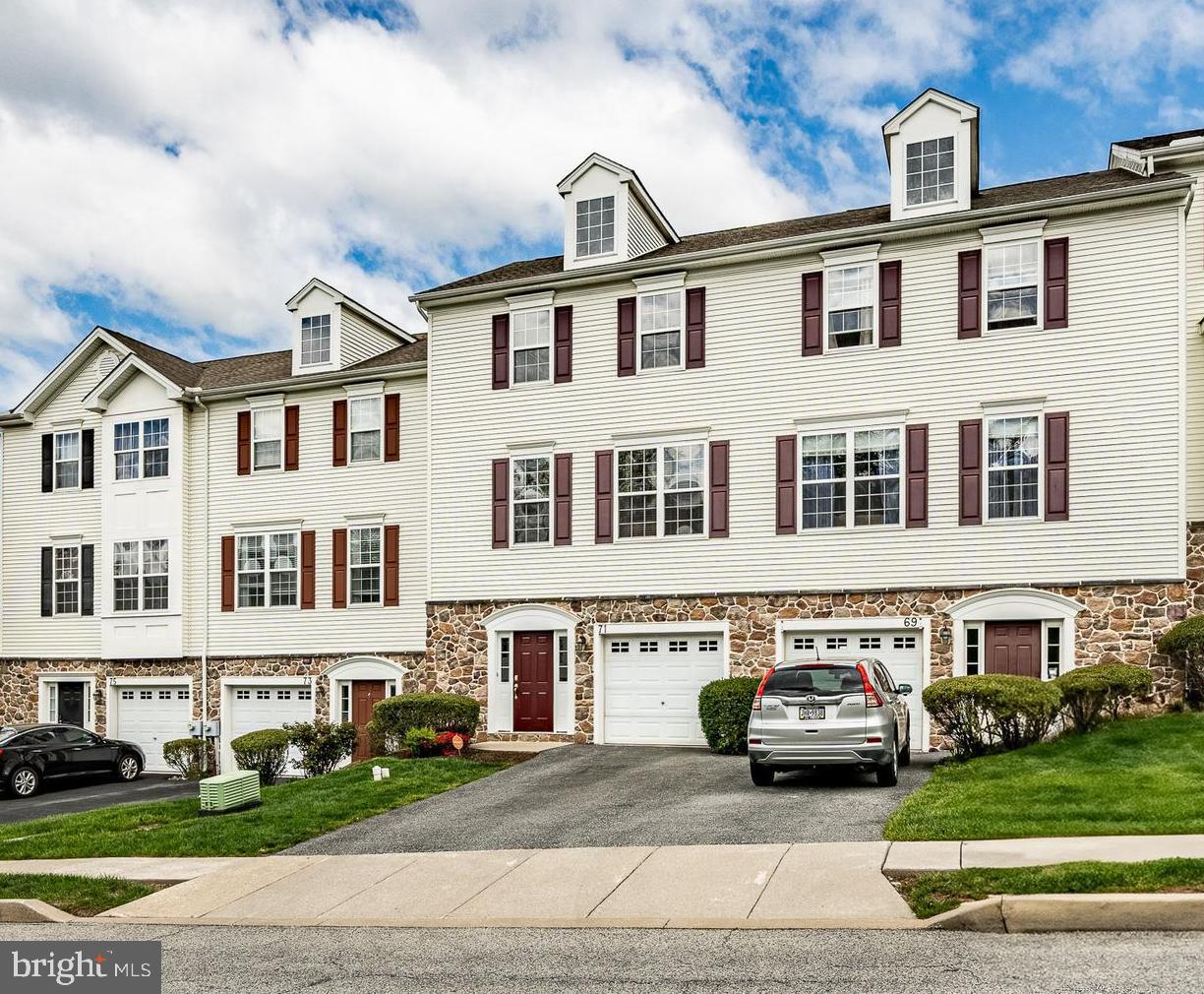 Welcome to this stunning townhome in the highly desirable Providence Hill community! This spacious 3-bedroom, 2.5-bath residence offers over 1,800 square feet of comfortable living across three thoughtfully designed levels. Step inside to an open-concept main floor featuring gleaming hardwood floors, 9-foot ceilings, and abundant natural light. The freshly painted interior is warm and inviting, complemented by brand new carpets on the upper levels and new waterproof flooring in the entryway. The heart of the home is a contemporary kitchen with ample cabinetry, a bright breakfast nook, and a seamless flow into the living and dining areas—perfect for entertaining. Upstairs, the generous primary suite boasts a walk-in closet and an en suite bath, while two additional bedrooms and a full bath complete the upper level. The finished lower level offers flexible space for a family room, home office, gym, or playroom, and opens to picturesque backyard views. Enjoy the outdoors from your Trex deck with sweeping vistas of the Chester County countryside. Recent upgrades include a new HVAC system (2022) and a new hot water heater (2025). Additional features include a one-car attached garage, driveway parking for a second vehicle, and low-maintenance exterior finishes. Located minutes from shopping, dining, major routes, and public transit, this home is also part of a welcoming community with walking trails, playgrounds, and HOA-covered lawn maintenance. Don’t miss your chance to own this move-in-ready gem—schedule your private tour today!