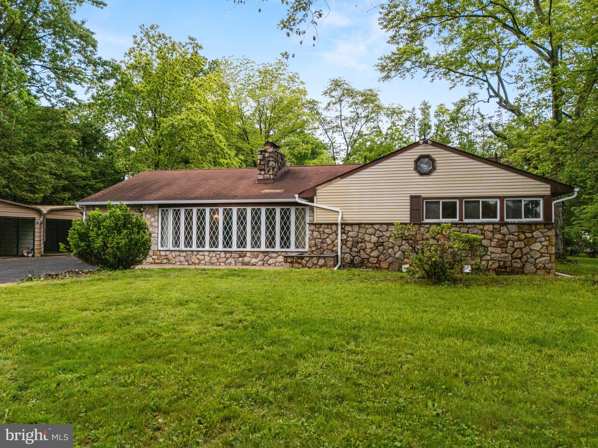 Welcome to this charming Glenside home on a full 1 acre lot, full of potential and ready for your personal touch. Step into the foyer with a spacious coat closet, leading into a sunken living room featuring a stunning floor-to-ceiling stone fireplace. This impressive centerpiece separates the living room from the adjacent dining area.
The bedroom wing offers a primary suite with an en suite bath, along with two additional generously sized bedrooms and a full hall bathroom. On the opposite side of the living room, you'll find a bright dining area with a large bow window that flows into the kitchen.
Just off the kitchen is the laundry room, which provides access to both the attached garage and an expansive sunroom at the rear of the home…perfect for relaxing or entertaining while overlooking the in-ground pool. A separate hallway from the kitchen also leads to the sunroom and finished basement.
The lower level offers fantastic entertaining space, complete with a wet bar, cozy sitting area, two impressive stone fireplaces, a large recreation room, and a full bath. You'll also find a dedicated Jacuzzi room with a built-in spa tub…ideal for unwinding at the end of the day.
Outside, enjoy a spacious, level yard, in-ground pool, detached two-car garage, and a two-car carport…plenty of room for vehicles, storage, and more.
This home is ready for updates and your vision. Don’t miss the opportunity to make it your own!