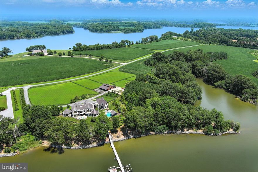 Welcome to Henry’s Retreat, an extraordinary 37-acre waterfront estate overlooking Quarter Cove off the Wye River. Offering over 2,700 feet of shoreline, this stunning property ensures ultimate privacy, breathtaking views, and unforgettable sunsets.

Built in 2016, the 8,835 sq. ft. main residence is designed for luxurious living and seamless entertaining, featuring five bedrooms, six full baths, and two half baths. The main-level primary suite boasts sweeping water views, an expansive ensuite dressing room/closet, and a spa-like bath with a glass-enclosed walk-in shower, soaking tub, and private laundry. The heart of the home is the chef’s kitchen, bathed in natural light and equipped with a granite center island, Thermador stainless appliances, and a striking barrel-vaulted ceiling. The adjoining sunroom, with its octagonal pitched ceiling and 180-degree windows, is anchored by a beautiful stone fireplace. The great room impresses with soaring ceilings and a woodburning stone fireplace, while the dining room showcases custom barnwood accents and wine storage.

The second level features four additional bedrooms (one currently an office), four full baths (three ensuite), a fitness room, secondary laundry, and a conservatory overlooking the great room. The finished lower level is an entertainer’s dream, complete with a theater room, billiard area, wet bar, full bath, and ample storage.

Equestrian enthusiasts will love the thoughtfully designed five-stall barn, each with a private paddock. The barn also includes a heated wash stall, climate-controlled tack room, bathroom, laundry, hay storage, and an enclosed equipment shed. A regulation-sized dressage ring and four interlocking fenced pastures further enhance the property. Complementing the estate’s natural beauty are eight raised garden beds and a charming orchard with apple and peach trees.

Waterfront amenities include a 125’ private pier with three slips, three boat lifts, water, electricity, and deep water (7’-8’+/- MLW). Rounding out this exceptional retreat are an attached three-car garage with a dedicated workshop, an inground saltwater pool, a covered pavilion with an outdoor kitchen, and a hot tub.

Truly a one-of-a-kind offering, Henry’s Retreat is the perfect blend of luxury, recreation, and serenity.

Close to fine dining, shopping, theater, galleries, and Easton’s jet airport, the property is conveniently located 1.5 hours from DC and Baltimore, and 2 hours from Philadelphia.