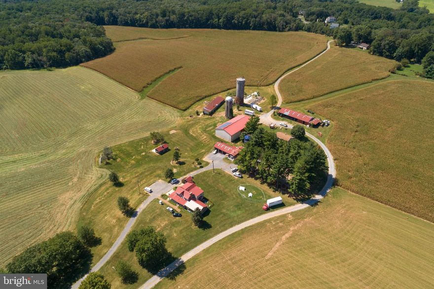Welcome to Timberleigh Farm, home of the Martin Family for over 64 years where Bill and Phyliss Martin raised 11 children .  This 133 acre Dairy Farm is now being offered  to the public for the first time. The farm boasts 1300 feet+/- of road frontage and gently sloping Glenelg Loam soils that are excellent for growing a variety of crops. Currently 90 +/- acres are tillable on the farm with record breaking yields. There is also 28 +/- acres of majestic  woods with a variety of timber that could possibly be sold. The property has 3 homes on the farm. The main farm house currently rented, the bunk house under renovation, and the romantic cabin .  The cabin on the back of the farm was recently remodeled and offers miles of glorious views of the farm and western Howard County. One experiences a calm looking over the farm from the large wrap around deck of the cabin.  A cell tower lease of $1295 +/-  per month will convey with the property. A 105x54 barn also has solar panels that offset the electric bill. The family has hosted a number of events and weddings on the farm. .  The farms location is especially attractive located 45 minutes from DC, 20 minutes from the metro station, 30 minutes from Baltimore and 30 minutes from Frederick. The state road 94 gives you immediate access to interstate 70.  The vast estate is adjacent to two historic landmarks- the historic home of Andrew Ellicott the founder of Ellicott City and Annapolis Rock where quartz was mined many years ago.  The farm also has its own natural wonder of   Dry Falls  a rock formation located among the 100 year old trees.  Call today for your private tour of this wonderful estate located in western Howard County.