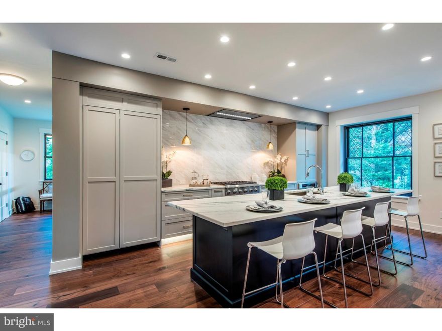 This spectacular beauty has all of the charm of a 100+ year old home, but has been completely renovated and transformed to create the hippest look in S Wayne!! Weiss & Associates was hired by the current owners to undertake this project, and the results are an extraordinary tribute to this turn-of-the-century home while giving it a new Hollywood Regency style. The property's corner lot has a commanding neighborhood presence, and one of the most beautiful covered front porches in Radnor Township. As you enter the front door one is completely "wowed" by the homes renaissance as many walls have been removed and there is an open floor plan not typically found in a home of this era. Materials of brass, smoked glass and hardwoods are mixed with colors of black, gold, cream and honey. Details of lacquer and geometric patterns with splashes of jewel tones add a refreshing new look while old leaded glass windows preserve the character of the home. The First Floor is a series of sophisticated spaces that gracefully flow from Living and Dining areas with dry Bar into the stunning Kitchen providing an entertainers dream. Every detail was carefully choreographed so it would function as a chefs delight, while aesthetically blending into other open rooms. The floor plan is further maximized as all closets have a purpose, and there is a Desk area, Laundry/Mudroom, and Powder Room to complete the First Floor. The original newel post and rail staircase carrys you to the Second Floor where there is a stunning Master Suite with His/Her walk-in closets, and gorgeous marble Master Bath. There are two additional Bedrooms with brand new Hall Bath and Bonus Room that could be used as an Office, or Playroom. The Third Floor hideaway has a generously sized Bedroom and new Bath with large soaking tub. The Basement has been completely water proofed and could be finished as additional family friendly space plus provides generous storage space. Every square inch of the interior of this home is BRAND NEW from behind the walls with all new plumbing, electrical wiring, and insulation... To new windows, drywall, trim and doors, flooring, plumbing fixtures, cabinetry, gas fireplace and recessed lighting, and so much more!! Walking distance to downtown Wayne and train!! This is exactly what you have been waiting for, so don't miss it!!