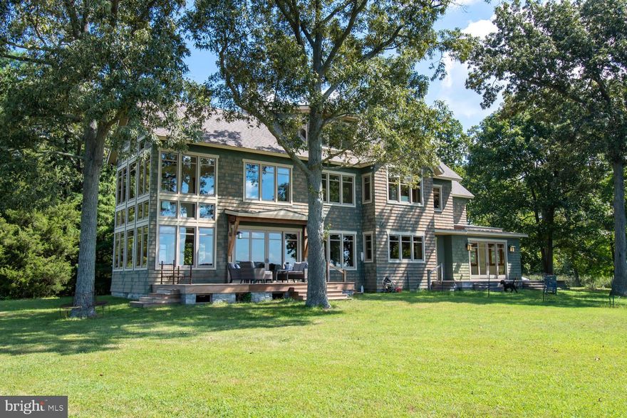 Extremely private waterfront home sited on 5.53 +/- acres on the totally rip-rapped 750' of the Choptank River.  The magnificent 5244 sq. ft. home's interior is a Craftsman style, Greene and Greene inspired design, many of which are listed in the National Historic Register.  Enter the handsome red cedar shake sided front entrance to an open, awe inspiring, quartzite stone floor, along with oak flooring, to a beautifully windowed floor plan of living room, den, spacious dining area, massive Temp Cast fireplace, gourmet kitchen and breathtaking views from each area.  The main level also incorporates a large, functional butler's pantry, utility room, tile and granite full bath, large artist's studio with enormous overhead fixed sky light as well as a screened green house.  

The house is beautifully sited offering Northwest and Southwest views over the open water of the Choptank River with the promise of magnificent sunsets throughout the year. 

Take the elevator to the second floor, or access the beautiful custom crafted stairway, to find two large oak floored primary bedrooms, each with generous en-suite baths using tile and granite (one wheelchair accessible), as well as tremendous walk in and open door closets.  Also discover a laundry room as well as a handsome office all with stunning water views throughout.  The third level offers an enormous oak floored open family room with a possible outside deck, guest bedroom and bath.

Storage is abundant on every level along with geothermal HVAC and radiant heat, Loewen double paned casement windows and doors throughout.  There is a climate controlled crawl space with concrete slab floor as well as 3 sheds, a sandy beach, Ipe zero maintenance outside decks, copper roofing, a whole house vacuum system and a back-up propane generator.  This must see property will bring to light a number of other amenities encompassing this thoughtfully planned property.