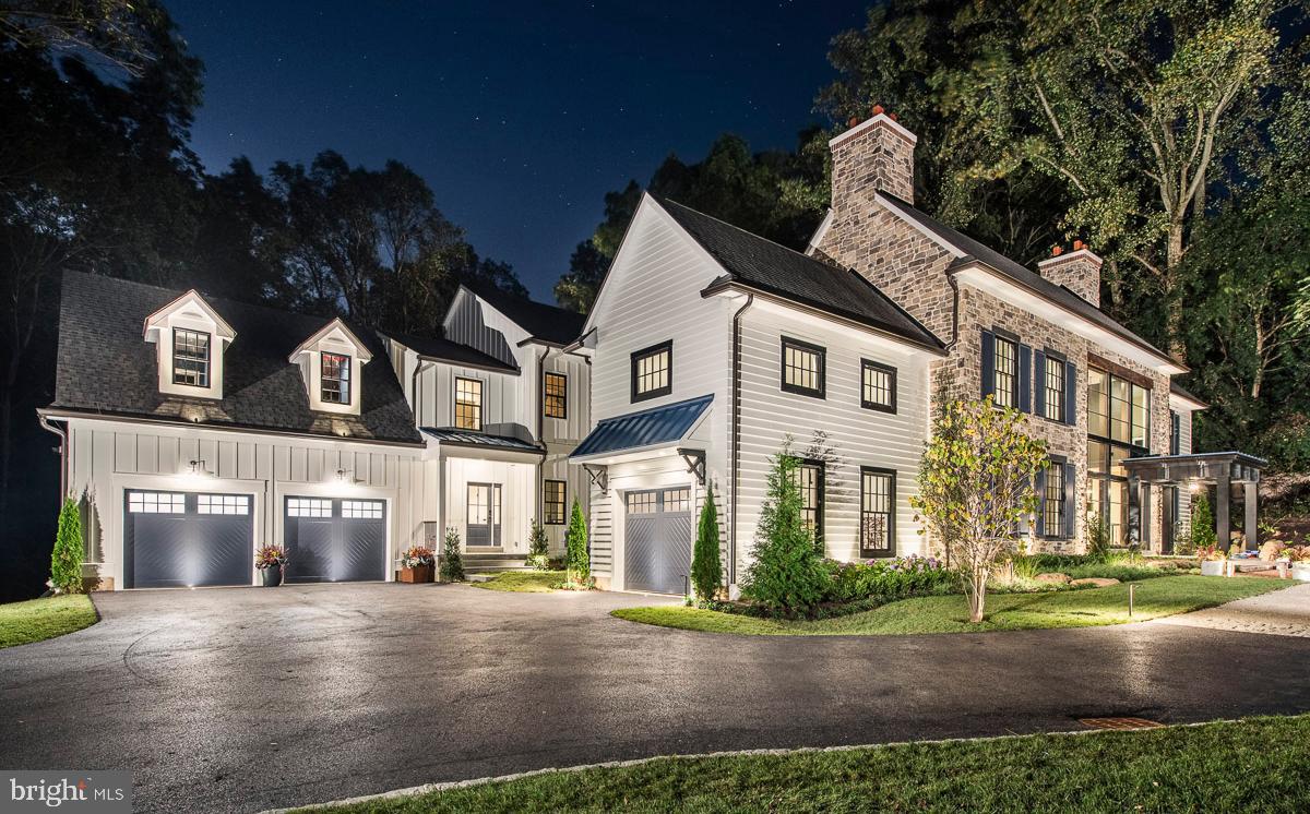 Stunning Modern architectural styling with a dynamic floor plan on a 2.9 acre homesite in Villanova PA built by Mark Weiss. Featured as this year's Philadelphia Magazine's 2019 Design Home. Salvaged materials such as reclaimed wood beams are used to accent a neutral palette. A creative blend of textures including stone, wood, and metal diffuse and reflect daylight through full walls of glass. Statement lighting continues to make the home glow once the sun goes down and adds to the overall feeling of comfort and warmth. Striking details catch your attention as you enter each new space. A floating staircase greets you inside the impressive three-story foyer that offers views from the front of the home straight through to the outdoor terrace. Three generous fireplaces warm the first floor spaces and invite people to gather and stay for a while.
