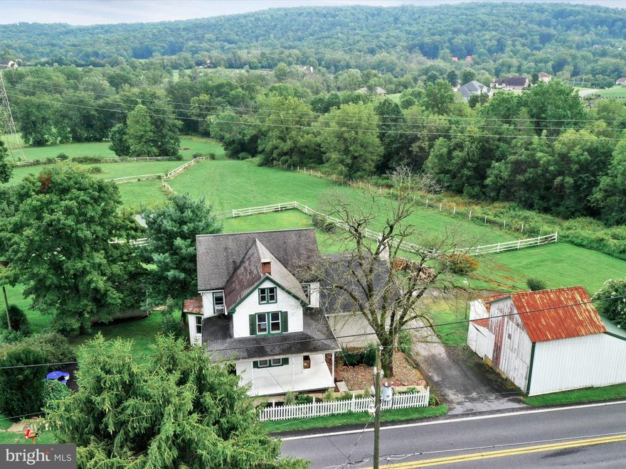 Are you looking for a property to create self sustainability? Look no further with 6.25 acres you can have a garden, animals, and possible business on site (check with township on allowances). There is a 40x60 garage with separate electric meter and 4 -10x10 overhead doors. Lower level of garage has 4 animal stalls, wash bay and storage area. The house has a beautiful family room addition with cathedral ceilings, floor to ceiling redstone fireplace and beautiful view of the pastures. Lower level of addition has the possibility to be an in law area or efficiency studio apartment since it has separate outside entrance and full bath. Original section of home has 3 bedrooms and 1.5 baths with washer dryer hook ups on 2nd floor and in the basement! Walk up attic could be used as more living space.  See floor plan in documents. There multiple other small out buildings for storage on the property plus some run in sheds for animals. Check with township on animal allowances. Pastures are fences with an electric vinyl fencing.  There are 2 wells on property one is located in lower pasture area and was used previously for watering the animals.