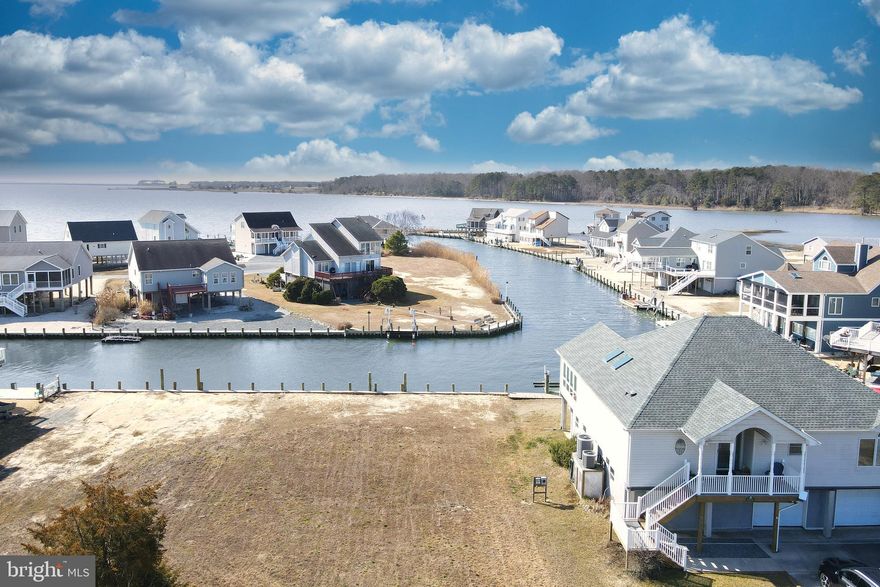 3/1443 Location, Location, Location! One of the best waterfront properties in Captains Cove that has Southern views of the Chincoteague Bay. Enjoy the beautiful sunsets and launches from Wallops Island from the comfort of your own private deck. Protected canal front lot that feeds directly into the Chincoteague Bay, come and see for yourself and you will agree! To appreciate the view I encourage you to step outside your car and walk to the back of the lot...PRICELESS!!! Approx. 61' of new vinyl bulkhead, Seller has starting prepping the lot for building and has Soils Studies. HOA amenities: Pristine 9 Hole Golf Course, indoor/outdoor pools (2), fitness center, basketball, tennis court & pickle-ball courts, playground biking & walking trails, dog park, security boat ramp and so much more.