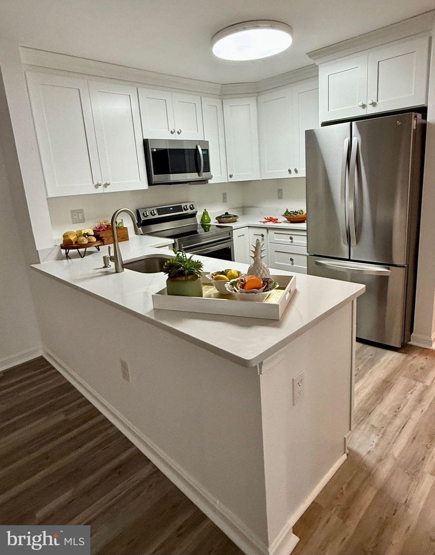 Opportunity to own a beautifully remodeled condo under $400,000! This updated mid-level 2BR/2BA unit in Manchester Lakes features a renovated kitchen with 36” white shaker cabinets, quartz counters, and stainless appliances. Open layout with vinyl plank flooring, wood-burning fireplace, balcony, and dining area. Spacious primary suite with walk-in closet and updated en-suite bath. New LG WashTower, HVAC, and water heater (2023). Reserved parking space in front. HOA covers water, sewer, trash, snow removal, exterior maintenance, and access to pools, gym, tennis, tot lots, trails, and clubhouse. Just 1.7 miles to Metro, close to I-95/395/495, Kingstowne, Amazon Fresh, and Springfield Town Center.