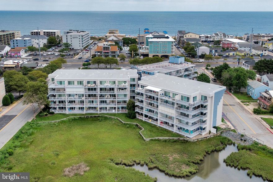 Welcome to Unit 403C at Triton's Trumpet — a spacious, move-in ready 2-bedroom, 2-bath condo on the fourth floor of one of midtown Ocean City's most sought-after bayfront buildings. Situated at the narrowest stretch between the Atlantic Ocean and the Assawoman Bay, this location delivers the best of coastal living: easy beach access, bay views, and a vibrant midtown corridor right outside your door. Midtown offers easy access to all Ocean City has to offer and beaches that allow you to spread out and relax

Step inside to a bright, open living area finished with LVP flooring, soft coastal colors, and sliding glass doors that open to a generous covered balcony overlooking the pool and courtyard — an ideal spot for morning coffee or evening entertaining. 

The kitchen is well-appointed with granite countertops, stainless steel appliances including a Bosch dishwasher, a tile backsplash, and bar seating that keeps the space social and functional. Whether you're cooking for the family or keeping it casual, this kitchen delivers.

The primary suite is a true retreat — king-sized, with its own private balcony access, and an en-suite bath featuring a double vanity with fresh white countertops. The second bedroom is equally well-proportioned and ready for guests or rental occupancy.

Triton's Trumpet is a professionally managed, well-maintained building with a newer roof, low condo fees, an outdoor pool, hot tub, storage locker, elevator access, and assigned parking. The unit's strong rental history and turnkey condition make 403C an attractive option for investors, second-home buyers, and those looking to enjoy the beach life without the maintenance headache.

Unit 403C is offered fully furnished and move-in ready with new keyless entry — just bring your beach chairs.

Walkable to Ropewalk, The Hobbit, Saltwater 75, Bayside Skillet, and more. 1.5 blocks to the ocean. This is coastal living without compromise.