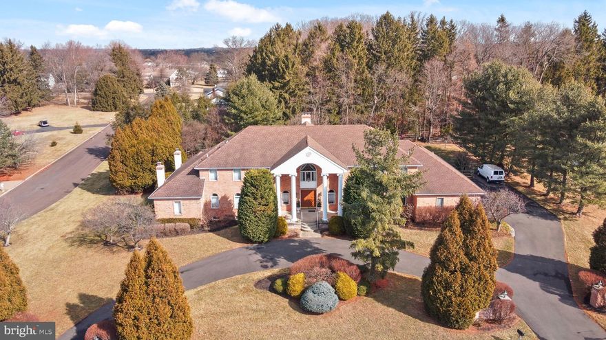 This breathtaking six-bedroom, five-and-a-half-bathroom estate is a true architectural masterpiece, offering an unparalleled combination of grandeur, elegance, and unlimited potential. As you approach the stately horseshoe driveway, the sheer magnificence of this home is immediately apparent. The distinguished facade, framed by lush, mature landscaping, sets the stage for the opulence that awaits inside.
Step through the impressive double doors into a grand two-story foyer, where a stunning butterfly staircase commands attention. To your left, the formal living room boasts gleaming hardwood floors and expansive windows, flooding the space with natural light. Adjacent is a distinguished office, complete with rich hardwood flooring, intricate crown molding, and a cozy wood-burning/propane fireplace, an ideal retreat for work or relaxation.
The formal dining room, adorned with crown molding, a chair rail, and exquisite hardwood floors, is perfect for hosting lavish gatherings. A well-appointed butler’s pantry with granite countertops and ample storage seamlessly connects to the gourmet chef’s kitchen. Featuring a massive center island, top-of-the-line stainless steel appliances, a Wolf gas range, a Sub-Zero refrigerator, and gleaming tile floors, this space is designed for both function and style. The adjacent sunroom, bathed in natural light from its skylights, offers panoramic views of the resort-style backyard and pool.
The main level also includes a spacious family room with a wet bar and direct access to a private patio with gazebo, creating the perfect setting for entertaining. A first-floor primary suite offers a private sanctuary, complete with an ensuite bathroom featuring a tub shower, and an oversized walk-in closet.
Upstairs, the second primary suite is nothing short of spectacular, with soaring vaulted ceilings, a tranquil sitting area, and an ensuite boasting a double vanity, Jacuzzi tub, separate stall shower, water closet, and an expansive walk-in closet with a dedicated makeup area. The left wing of the second floor features two generously sized bedrooms with walk-in closets and a well-appointed hall bathroom, while the right wing mirrors this layout, ensuring comfort and privacy for all.
Descending to the expansive lower level, you'll be amazed by the sheer versatility of the space. Currently equipped with a wet bar and multiple oversized rooms, this level is a blank canvas for a home theater, media lounge, fitness center, or additional living quarters—the possibilities are endless. Plus, there's an abundance of storage space to accommodate every need.
The outdoor oasis is truly a retreat, highlighted by a sparkling in-ground pool surrounded by lush greenery, creating a private paradise. For added convenience, a dedicated pool room with a full bathroom ensures seamless indoor-outdoor living.
Situated in the prestigious Council Rock School District, this extraordinary home presents an unparalleled opportunity to own a piece of refined elegance with endless potential. With its stately presence, thoughtful design, and unmatched entertaining spaces, this is a rare offering that must be seen to be believed!