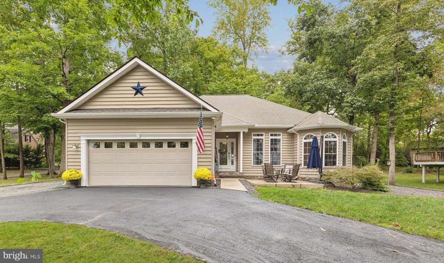 Welcome to this stunning one-level home, located in the sought-after gated lake and golf community of Lake of the Woods offering an array of amenities, including a pool, private beach, equestrian center, lake privileges and so much more! Situated on a prime .27  acre corner lot with  lake views, this property is a must see gem!  
The home features gorgeous oak hardwood floors throughout, creating a warm and inviting atmosphere. The spacious great room is perfect for relaxing or entertaining, with a gas fireplace (serviced in 2023) and beautiful custom built-ins. A formal dining room offers a stylish setting  located right off of the great room. The light filled kitchen has been updated within the past few years to include  new flooring, appliances, lighting, tile backsplash, and butcher block countertops.. Also includes a walk in pantry with plenty of storage space!
The primary bedroom is a private retreat, complete with a versatile sitting room that can serve as a private office, nursery, or just a cozy getaway. Also featuring 9 ft tray ceiling, walk in closet, and  bath with dual sink vanity, walk in shower and large soaking tub.  Two additional bedrooms,  a  full bath, and a great sized  laundry room complete the layout.
Outside, a circular driveway and a 2-car garage provide ample parking and curb appeal. Many recent updates including  an 18 Seer TRANE HVAC (2018) and 50 gallon water heater (2022).  An additional feature includes 3M protective film on all windows and glass for added energy efficiency and security! 
This home offers a rare opportunity to enjoy luxurious living in a community rich with amenities, stunning lake views, and serene surroundings. Don’t miss the chance to make this incredible home your own!