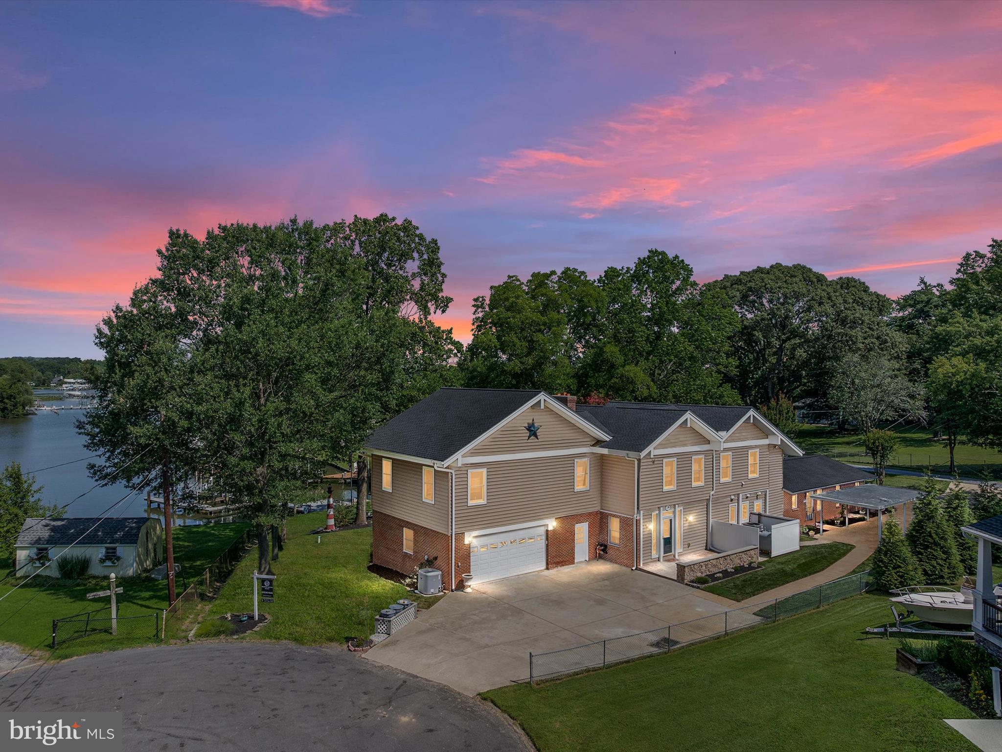 1207 Bay View Court is more than a waterfront home—it’s where life slows down and every moment feels like a getaway. Perfectly situated in a serene, protected cove with 5-foot MLW and a private dock with three boat slips, this property is made for the boating enthusiast, the entertainer, and anyone who dreams of waking up to the sparkle of the South River. Inside, the home tells a story of versatility and warmth. The first floor blends the character of the original home with a modern expansion, offering two kitchens, two bedrooms, 2.5 baths, and a full laundry room—ideal for multi-generational families, long-term guests, or even creating a private in-law suite. The gourmet kitchen is a centerpiece for gatherings, opening to a sun-drenched dining room and family room with walls of glass that frame the water like living art. Imagine cozy evenings by the pellet stove with its dramatic stone wall or sipping morning coffee in the waterside Florida room as the sun rises over the cove. The second floor is an entertainer’s dream, with a huge bar, soaring vaulted ceilings, and a great room designed for holiday fun, game-day parties, and sunset toasts. Two additional bedrooms, two full baths, and a second laundry area provide space and comfort for everyone. Hardwood floors throughout add warmth and timeless style. Outdoors, expansive waterside decks invite summer crab feasts, while the oversized two-car garage, carport, and generous parking make hosting effortless. Living here means more than just owning a home—it’s embracing a lifestyle. From launching your boat for a day on the Chesapeake, to teaching the kids to paddleboard, to dining al fresco under the stars, every day is an opportunity to connect with nature and with each other. Nestled in a sought-after Edgewater community with top-rated schools and a friendly, close-knit atmosphere, this property is destined to be “the” house for every celebration, holiday, and waterfront memory you’ll ever make.
.