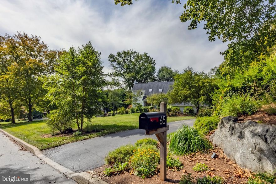 If you’ve been looking for a completely turnkey contemporary home, on a magnificent lush ¾ of an acre lot, also in a coveted neighborhood, this is your opportunity.  This stunning home has been tastefully renovated by its current owners and offers a breath of fresh air at every turn.  The craftsmanship, quality of materials and design of all the updates makes it a phenomenal value and a one of a kind.  Welcome to 65 Roberts Rd, where you feel at home the moment you walk in the door and where the location offers a certain lifestyle you’ll never get tired of.  With over 3,000 square feet of above grade living space, large windows & skylights throughout and a versatile floor plan, this home makes you feel like you’re somewhere else.   Enter at the herringbone slate tile foyer.  The main level has a great flow to include a completely renovated kitchen with two tone Kemper cabinets with modern oak in the mix, a large center island, quartz countertops, upgraded appliances such as a Fisher and Paykel dual fuel oven, a Thermador fridge, glazed zellige tile, recessed lighting, a workstation sink, Uline bev fridge, wall mounted fireplace and a wonderful sitting room that can double as a breakfast room.  The oak flooring in gleaming shape sprawls throughout this level of the home.  The dining room is large in size and can accommodate a nice sized table and server.  The living room has a fireplace as well and it’s the perfect room to overlook the property all year long.  The back of the home features ceiling to floor windows, making this whole level feel so open and bright.  The mudroom is amazing, with access to the 2 car attached garage for convenience and also features the herringbone floor for continuity, built in custom cabinetry, cubbies, a bench and 1st floor laundry!  Who doesn’t love that?!  The powder room is perfectly tucked away as well.  Enjoy easy access to the large back deck off the main level, perfect for entertaining your guests or to simply enjoy your morning coffee.  The 2nd floor has 3 large bedrooms to include a primary suite.  The primary has a stunning recently renovated bath with a gorgeous shower with a skylight, large double vanity, a soaking tub and custom tilework.  The primary also includes a large walk-in closet and a balcony.  The 2nd and 3rd bedrooms are very large in size and have newer carpeting, recessed lighting and ceiling fans.  The hall bath is newer, fresh and has a double vanity and modern tilework.  The walk-out lower level of the home features a ton more living space with its large rec room with a 3rd fireplace, custom built- in with a wet bar sink and beverage fridge, a beautiful half bath and a large office that could certainly double as a 4th bedroom if needed.  The current owners spared no expense at making this home what it is today.  The electrical was updated, new windows (all except the large ones on the back of the home), new front door, kitchen door, garage door and the French doors in the basement.  New Hardie siding, new gutters, the renovation of the primary bath, the basement and its half bath, a complete mudroom renovation and the kitchen renovation.  The storage throughout the home is awesome, from the thoughtful closets to the large garage.  The list of why this home is amazing goes on and on!  The location can’t be beat if you enjoy peace and quiet, but like being in a neighborhood.  It’s the best of everything and offers a great accessibility to all things Main Line, great shopping and dining at the New Village at Ellis Preserve, Ellis Athletic Center, amazing local schools and so much more.  This home is one of the most loved, thoughtfully updated and pristine homes you’ll ever see.
