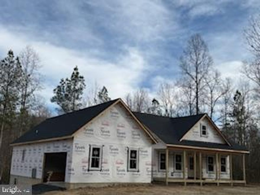 Nestled on a generous 2-acre lot, this exquisite ranch-style residence is a canvas awaiting your personal touch. With construction set to be completed in 2026, this home offers a unique opportunity to customize your living space while enjoying the luxury of modern design and high-end features. As you approach the property, the charming exterior, adorned with durable vinyl siding, invites you into a world of comfort and elegance. The side-entry garage, complete with a garage door opener, provides both convenience and a polished aesthetic. The expansive lot backs to lush trees, creating a serene backdrop that enhances your privacy and connection to nature. Step inside to discover a thoughtfully designed layout that maximizes space and functionality. The heart of the home features a spacious kitchen equipped with stainless steel appliances, including a sleek oven/range and a dishwasher, perfect for culinary enthusiasts. The open-concept design flows seamlessly into the living areas, where natural light pours in through energy-efficient double-pane windows, ensuring a warm and inviting atmosphere. With three well-appointed bedrooms and two full bathrooms, this home is designed for comfort and relaxation. The main floor laundry adds an element of convenience, making daily chores a breeze. The unfinished basement offers endless possibilities, whether you envision a cozy family room, additional bedrooms, or a personal gym. With rough plumbing already in place, the potential for customization is limitless. Luxury extends beyond the interior, as the property boasts a tranquil porch, ideal for morning coffee or evening gatherings. The surrounding wooded area not only enhances the beauty of the landscape but also provides a peaceful retreat from the hustle and bustle of everyday life. This home is not just a residence; it's a lifestyle. Embrace the exclusivity of living in a space that combines modern amenities with the tranquility of nature. With no association fees or community restrictions, you have the freedom to create your own oasis. Don't miss the chance to make this exceptional property your own, where luxury meets comfort in a setting that feels like home.