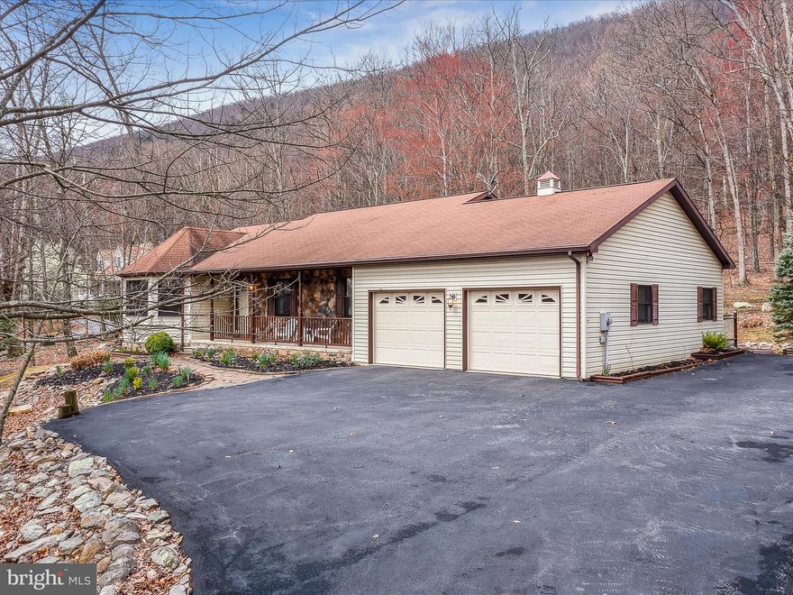 Retire in style or start your life off right here!  Nice subdivision where you can enjoy all the nature has offered without giving up any conveniences.  This charming single story home sits on 2.72 wooded acres with a view of the mountains.  Home offers:  2 bedrooms, 2 full baths, kitchen-dining room, living room, den with wood burning fireplace and door onto the screened in porch.  Main level laundry room, 2 car attached garage with workshop or mudroom.   Basement has a large finished  family room.  Lots of storage or space to finish for additional living space.