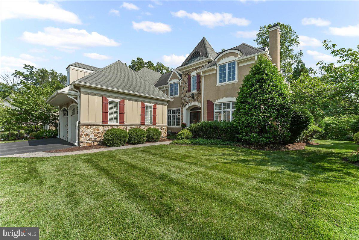 One of the premier properties in the Haverford Reserve community! This stunning “Pembrey” model has exceptional indoor and outdoor spaces. You will appreciate the thoughtful upgrades and design choices throughout. The home can expand and contract for day-to-day living and when you have your favorite visiting family and friends. With a premium lot backing to the wooded Reserve, the two-tiered entertaining spaces, topped off by an Ipe wood deck and pergola, will be an area where you will make many memories.
The Main Level’s center is the beamed Great Room with a built-in entertainment center, a manteled fireplace and streaming sunlight. There is, also, a formal Living Room with a transomed entrance and custom milled fireplace surround; a large Home Office (currently being used as a Billiards Room), and a Breakfast Room leading out to the deck. There is a lovely Powder Room and a well-outfitted Mud Room leading out to the spacious two car Garage. The main level and upstairs hall are outfitted with wide-plank, site finished hardwood floors, and plantation shutters grace the windows throughout the home. The whole house Sonos music system sets the mood for your day.
The unique Kitchen has rich cabinetry and display cabinets for your collectables. The appliances include Wolf double ovens, a Wolf induction cooktop, built-in microwave, and Miele dishwasher and refrigerator. Leathered granite surfaces complement the tone of the kitchen. Adjacent to the Kitchen is a Butler’s Pantry with a wet bar, a mini-refrigerator and stylish storage connecting the formal Dining room.
Take the elevator or sweeping staircase up to the second floor and you will find an elegant Main Suite with upgraded millwork, custom his and her closets and a vaulted ceiling main Bathroom. Finally, there are two additional Bedrooms each with a private ensuite Bathroom and a spacious Laundry Room.
The walkout Lower Level is a multi-functional floor. The main area has a media space for listening to music and watching TV, a sitting area for games and conversation and a working office with a wet bar and refrigerator. This level has a beautiful full Bathroom and two rooms that are currently used as Bedrooms. The Bedrooms can easily be converted to dedicated exercise space if desired.
The Haverford Reserve is set among 120 acres of parkland with walking trails; there is a Community Recreation Center; playing fields and a dog park. The location is just minutes from the Septa train and a short drive to Center City and the Philadelphia International Airport.