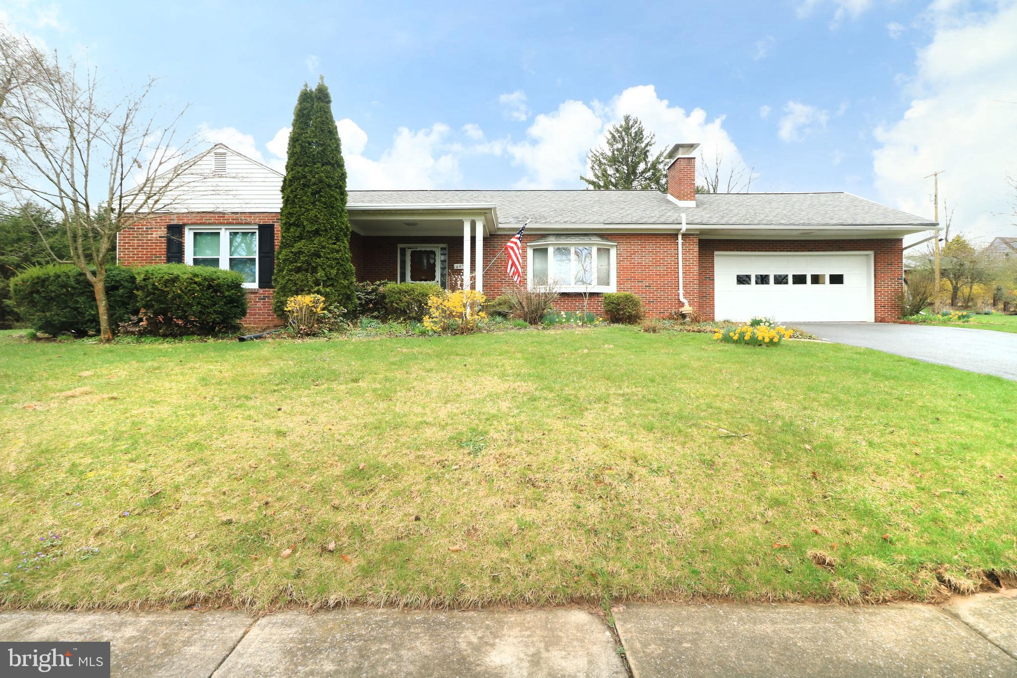 Discover the charm of State College Borough along tree-lined streets in a welcoming, well-established neighborhood. Nestled in the Highlands on serene E McCormick Ave, this sturdy brick ranch warmly invites you to experience true one-level living. Set on a generous 0.49-acre lot adorned with lush, mature landscaping & striking curb appeal, this move-in-ready home radiates care & character. Upon entering the bright foyer, you are greeted by a spacious living room featuring a cozy brick wood-burning fireplace, built-ins & a delightful bay window—a perfect setting for relaxation & memorable gatherings. The darling dining room flows seamlessly into a fully equipped kitchen. Outfitted with included appliances, a tasteful tile backsplash & solid wood cabinetry, the kitchen is designed for creating culinary delights. Adjacent to the kitchen, the convenient main-floor laundry/mudroom features a washer, dryer, extra storage, entrance to the attached garage & a separate exterior entrance to the backyard. Sunlight cascades throughout the home, particularly into the 21x9 sun-kissed sunroom. Featuring ceramic tile flooring & serene views of the peaceful backyard, this sun-drenched retreat offers an ideal space for relaxation or a casual work-from-home setup. A large rear deck off the sunroom provides the perfect venue for entertaining guests during Happy Valley weekend events. Retreat to the private owner’s suite, complete with a personal full bathroom featuring a walk-in tile shower. 2 additional bedrooms & a second full bathroom offer comfortable accommodations for family members or visiting guests. Completing the package is a spacious unfinished basement for extra storage & an attached two-car garage, ensuring that practicality meets charm. Located just moments from the vibrant energy of downtown State College & the excitement of Penn State University, this residence is perfectly positioned for both quiet living & an active lifestyle.