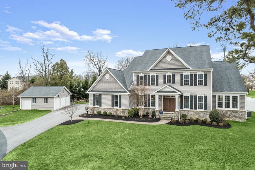 Absolutely remarkable six bedroom home built by Columbia Builders in 2016 offering over 8,000 square feet of exceptional living, set on a pristine 1.09 acre lot in Ellicott City. Showcasing sun-filled windows, a neutral color palette, recessed lighting, hardwood floors and so much more. Tucked away at the end of a quiet road, this magnificent home greets you with beautiful landscaping and a peaceful, tranquil setting. Enter into the foyer that highlights crown molding, and the front living room is great for lounging and enjoying a morning cup of coffee. The light-filled sun room has a soaring vaulted ceiling and a sliding door leads to a study that is ideal for an additional work space or play room. Kick your feet up and relax in the family room highlighted by a stone accent wall with a gas fireplace. Prepare your favorite meals in the open concept gourmet kitchen that is fully equipped with granite countertops, decorative tile backsplash, large center island with a breakfast bar and Bosch dishwasher, 42” soft-close cabinets with lighting underneath, stainless steel farmhouse sink, a double wall oven and a six-burner Wolf gas cooktop with built-in grill and range hood. The breakfast nook has space for any size table with a walk-in pantry and a workstation with matching granite countertops, and a wet bar with a sink and beverage refrigerator. Entertain guests in the dining room adorned with crown molding and chair railing. The main level also has a mud room with laundry and access to the attached two car garage and a door to outside. Finishing the main level, a convenient bedroom suite is ideal for long-term guests or those looking for an entry-level bedroom, with a private sitting room, walk-in closet, access to the deck and an ADA-accessible bathroom with a dual vanity and walk-in shower. Upstairs, the primary bedroom suite awaits with a tray ceiling, two-walk in closets, private office, and a luxurious bathroom with a soaking tub, massive walk-in shower with bench and a dual vanity. The second bedroom suite features an accent ceiling, walk-in closet and private bathroom. Down the hall, another two large bedrooms and a third full bathroom await. A second laundry room with custom built-ins including a hamper and fold-out ironing board complete the upper level. The fully-finished walk-up lower level has an expansive recreation room, a sixth bedroom, another full bathroom, storage room and an exercise room. Enjoy spending time outside on the rear deck that overlooks the fully-fenced backyard that is perfect for hosting any size gathering or party. Complete with an attached two-car garage with a ChargePoint electric vehicle charger, and a detached three car garage that provides additional storage.