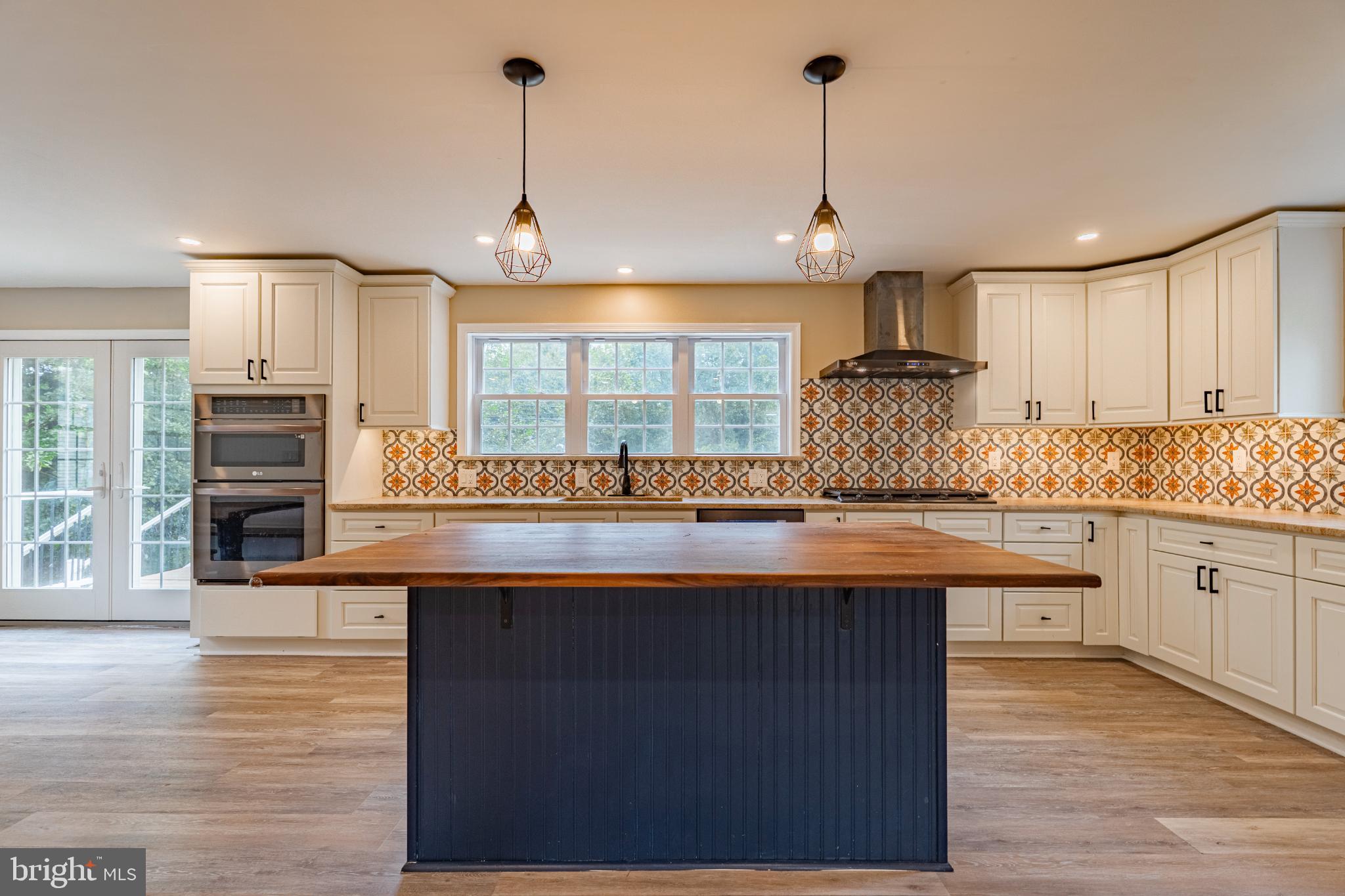 This charming stone home presents as an unassuming cape as you approach, but once inside, you will be delighted to see desirable, modern spaces behind the sweet 1950’s facade. A tasteful, two story addition was built in 2022, creating the living space that we want in a home today; connectivity between the kitchen, dining, and family rooms on the lower level, and an impressive master suite above. 604 Arlingham checks all of the boxes, prepare to fall in love!
As you approach the home, you are greeted by a delightful front porch. Inside, a spacious living room welcomes you into the home. The living room boasts a wood burning fireplace, plenty of windows, bringing in wonderful natural light, hardwood flooring, a coat closet, and views into the heart of the home. Beyond the living room, you will find the kitchen, dining area, and family room, all open to one another. This is an incredibly spacious and bright environment, where you will no doubt, spend most of your time. The kitchen boasts expansive leathered granite countertops, offering tons of work space, a beautiful backsplash, an oversized under mount sink, built-in wall oven and microwave, gas cooktop, a lovely island with walnut top and plenty of room for seating, and an incredible amount of storage space in the attractive two tone cabinetry. There is easy access to the rear deck, perfect for grilling. You will love the custom built banquette, table and bench; painted to match the cabinetry and topped with the same walnut used in the island, creating a seamless and sophisticated look. The banquette is not only adorable, but also functional, as the seats lift up for storage. The kitchen and dining area look over the family room, which can accommodate a sizable sectional and whatever else your heart desires. Not only is this layout ideal for everyday living, it is a dream for entertaining. Off the family room, you will find the laundry room and separate powder room.
Upstairs, you will find a master suite fit for a king (or maybe two, as you could fit two king size beds!). This bedroom offers plenty of space for a king bed, dressers, and a sitting area (or a great place for the peloton, work station, etc.). An abundance of windows bring in beautiful natural light and the vaulted ceiling creates a breezy feel. The ensuite bath is also extremely spacious, boasting an oversized walk-in shower and dual vanity. A walk-in closet completes this space. Two additional bedrooms, a shared hall bath, and linen closet, round out the second floor.
Down below, the basement offers plenty of storage space.
The yard allows room for play and gardening and is nicely privatized in the back. You will appreciate the large deck in the rear of the home; it was built in 2024, so it is in great shape and offers enough room for grilling, dining, and lounging. An attached one car garage completes the home.
Other important highlights include dual zoned HVAC (the second zone added in 2022), newer roof (main roof replaced in 2019 and addition roof added in 2022), and portable generator hookup (left side of garage).
The desirable Flourtown location is ideal for commuting and accomplishing every day tasks, as both shopping and transportation routes are all close by. Hop in the car and be in Ambler or Chestnut Hill in no time at all. A five minute walk takes you to Valley Green Park; eight acres offering a playground, swings, basketball courts, baseball field and walking paths. Sought after Springfield schools are the icing on the cake!
