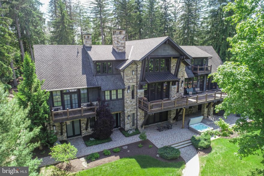 ICONIC. A design masterpiece of stone and timber — a true Rex Anderson build that reflects the seamless merging of inspiration and architecture. Warm, and undeniably welcoming, this home stands as a statement of craftsmanship and vision.
 
Discover a breathtaking blend of contemporary luxury and timeless timber frame construction, perfectly positioned for privacy within the prestigious Reserve at Holy Cross. Surrounded by soaring pines and set against the sparkling backdrop of Deep Creek Lake, this architectural gem offers a flawless fusion of indoor elegance and outdoor serenity.
 
Step inside to soaring exposed beam ceilings, floor-to-ceiling windows, and open, airy living spaces. The great room centers around a striking floor-to-ceiling stone fireplace, complemented by handcrafted timber details and expansive glass doors that open onto a sprawling lakeside deck. 
 
The chef’s kitchen is a modern centerpiece, featuring high-end appliances, granite countertops, custom cabinetry, and a generous island perfect for gathering with family and friends. The primary suite is a luxurious retreat, a spa-inspired ensuite, and dream walk-in closet. 
 
Throughout the home, no detail has been overlooked — from hardwood trim, solid wood doors, all of which, are hand-selected finishes that speak to quality and intention. Additional features include a fully equipped home gym and an energy-efficient geothermal system, ensuring sustainable comfort year-round.
 
Set on 1.3 acres with 160 feet of pristine waterfront, this exceptional property delivers both privacy and proximity to Deep Creek Lake’s finest amenities — from boating and skiing to dining and golf.
 
This is more than a home. It’s a lifestyle. A statement. Welcome to your lakefront legacy.