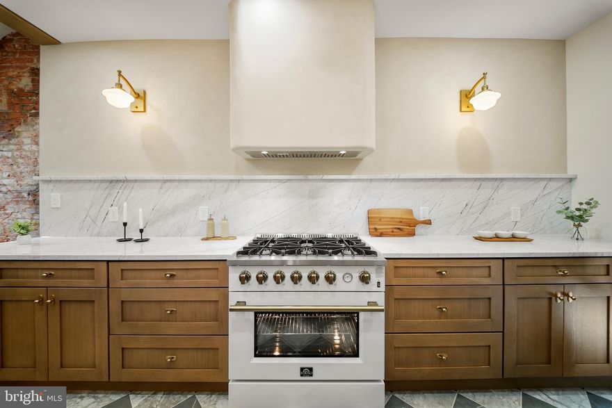 Step into a beautifully designed home where custom finishes, a chef’s kitchen, and thoughtful details create the perfect blend of style and comfort. Welcome to 2522 Thompson Street, a stunningly renovated residence located in the heart of Brewerytown, just steps from Fairmount featuring a 10 Year Tax Abatement . This thoughtfully designed home blends modern luxury with warm, custom finishes—offering a truly elevated living experience. Step inside to an open-concept main level featuring wide-plank hardwood floors, elegant shadowbox molding, and designer lighting throughout. The attention to detail is immediately evident, creating a space that feels both sophisticated and inviting. The kitchen is a true showpiece, highlighted by sleek marble countertops, custom cabinetry, and a statement plaster hood vent. A premium 6-burner gas range anchors the space, while exposed brick accents and brass finishes add warmth and character—perfect for both everyday living and entertaining. Upstairs, you’ll find three well-appointed bedrooms. The primary suite stands out with a beautifully designed accent wall and abundant natural light. Bathrooms are finished with high-end tilework, featuring spa-inspired details including a custom tiled shower niche and elegant brass fixtures. Convenience meets design with a dedicated laundry area, complete with built-in shelving and stylish finishes, as well as a main-level powder room with designer touches. The fully finished basement provides additional flexible living space—ideal for a media room, home gym, or guest suite. Step outside to your private rear yard, offering a clean, low-maintenance space perfect for entertaining or relaxing.