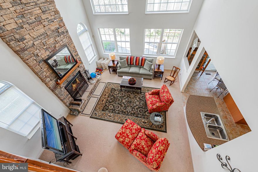 Welcome to refined coastal elegance in the sought-after community of Victoria Forest in Selbyville, Delaware and minutes from the beaches. This exquisite four-bedroom, 2.5-bath home is the perfect blend of sophistication, comfort, and thoughtful design—truly a standout property that defines luxury living.  From the moment you step through the front door, you’re greeted by a sense of grandeur. The living room is nothing short of breathtaking, featuring soaring floor-to-ceiling windows that flood the space with natural light and create an open, airy ambiance. Anchoring the room is a stunning floor-to-ceiling stone fireplace, adding warmth, texture, and a dramatic focal point that elevates the entire space. The upgraded kitchen seamlessly flows from the main living area, offering both style and function—perfect for entertaining or everyday living—while the formal dining room provides an elegant setting for gatherings and special occasions.  The first-floor primary suite is a private retreat that will leave a lasting impression. Spacious and serene, it is complemented by a stunning en-suite bath featuring high-end finishes, beautiful fixtures, and a luxurious soaking tub designed for ultimate relaxation. Upstairs, the home continues to impress with an open overlook that provides sweeping views of the main level below, enhancing the home’s dramatic architectural appeal. Three additional generously sized bedrooms offer comfort and flexibility for loved ones and guests, all thoughtfully designed with space and style in mind. A convenient walk-in attic provides ample storage and practicality.  This remarkable home is the epitome of upscale living in a peaceful coastal setting. With every detail carefully curated, it is truly a must-see to fully appreciate all it has to offer.