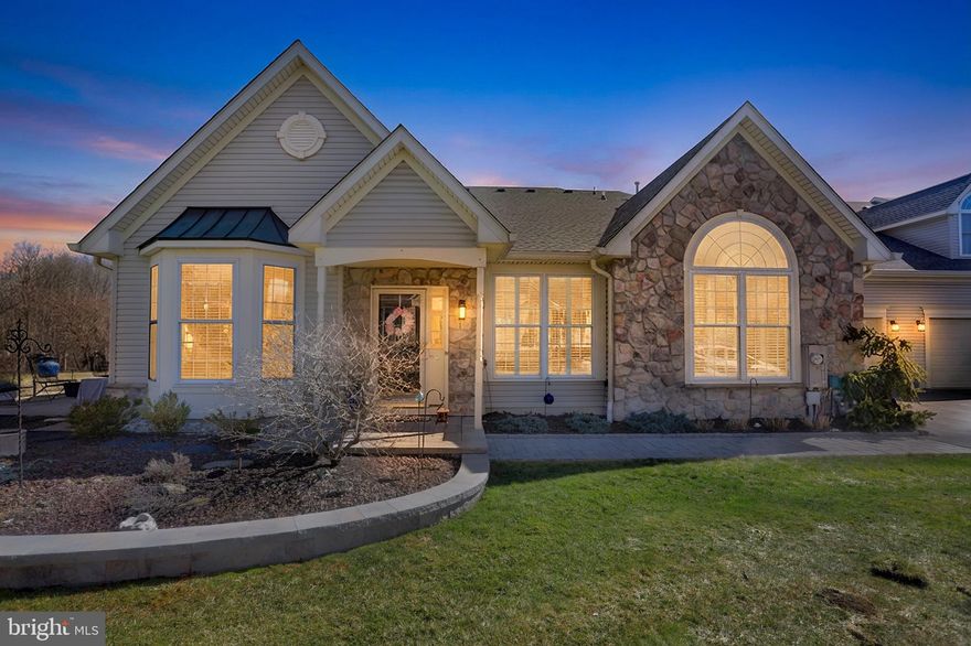 Nestled on a premium lot in the sought-after "The Villages of Flowers Mill" community, this exquisite McGrath-built Thornhill model villa offers serene views of open space and a picturesque pond with a fountain. Step inside and experience a home where meticulous design meets modern comfort, creating the perfect sanctuary.

The entry greets you with soaring vaulted ceilings, gleaming hardwood floors, and an effortless flow between the living spaces. The living room, adorned with custom plantation shutters, then transition seamlessly into the elegant dining area and the expansive family room. Here, a stunning floor-to-ceiling stone fireplace takes center stage, complemented by more custom shutters and an abundance of natural light. Just off the family room, the sun-drenched sunroom invites you to relax or step out onto the spacious paver patio, ideal for entertaining or soaking in the tranquility of the outdoors.

The heart of the home is the beautifully remodeled kitchen, a chef’s dream featuring expansive granite countertops, stainless steel appliances, a deep stainless-steel sink with garbage disposal, and custom cabinetry with upgraded trim, pullout shelves, and under-cabinet lighting. A timeless tile backsplash ties it all together, while the breakfast bar comfortably seats five. The adjacent eat-in area completes this warm and inviting space.

The luxurious master suite is a retreat of its own, boasting double walk-in closets, custom plantation shutters, and an opulent en-suite bathroom. This spa-like space includes two new vanities, a jetted soaking tub, stall shower, and a private toilet area. A second bedroom and full bath on the main level provide additional comfort and convenience.

Off the kitchen, you'll find a well-equipped laundry area with a sink, full-size washer and dryer, and access to the two-car garage, which features an automatic door opener, a storage closet, and built-in overhead shelving.

Upstairs, the versatile loft offers endless possibilities. Whether you envision a private yoga studio, craft space, guest quarters, or a cozy retreat, this area delivers with custom built-in floor-to-ceiling shelving, a full bathroom, and a closet for extra storage.

This home is an exceptional blend of thoughtful design, premium finishes, and peaceful surroundings. Schedule your tour today and make this Thornhill gem, your own!