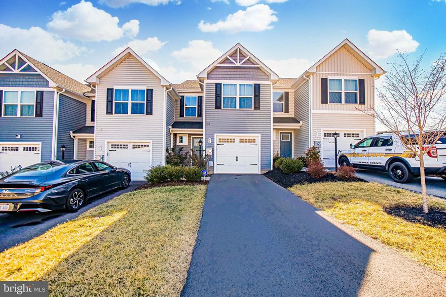 2023 built townhome available in Cardinal Pointe, one of Hedgesville premier subdivisions. WHY BUY NEW WHEN ALL THE HIGH-END FEATURES HAVE ALREADY BEEN ADDED!! The foyer has a powder room and walk-out to the one car garage. Gleaming LVP flooring on the entire main level. The foyer opens up into the combination kitchen/family room with a large center island, granite countertops, recessed lighting, stainless steel appliances, a pantry, and a walk-out to the patio giving you a magnificient view of the neighborhood. The upper level has thick and plush designer carpet with hallway laundry. Oversized primary bedroom with a walk-in closet, and an ensuite luxury spa with a dual sink vanity, LVP flooring, and a tub/shower. Two more spacious bedrooms on the upper level with ample closet space both share a full modern hallway bathroom! Monttain views, shopping, and dinning all close by!!I-81 and major commuter routes not far!!