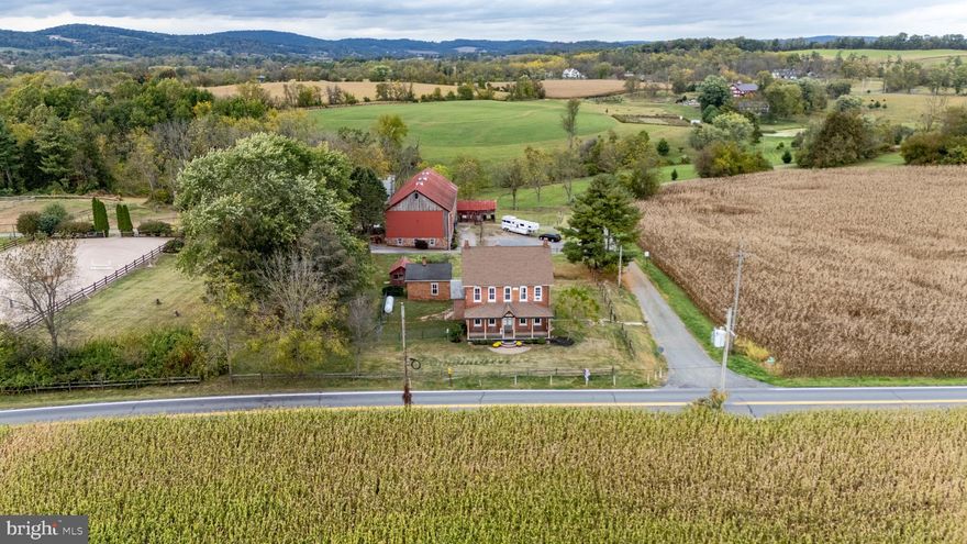 This property is being offered for sale at auction on WEDNESDAY, NOVEMBER 5, 2025 @ 4 PM. List price is the suggested opening bid only and is not indicative of the final sale price. Open House: Saturday, October 18 & 25 and November 1 (1-3 PM). Terms: 10% down day of sale; settlement within 45 days of sale. Terms By: Bleugrass Farms LLC.
House: Circa 1732, brick Victorian w/approx. 2,800 SF w/original wood floors, doors, hardware and crown moldings. Main Floor: Living room, dining room, eat-in kitchen w/appliances, walk-in pantry & full bath. 2nd Floor: 4 bedrooms & a full bath. 3rd Floor: 2 bedrooms. Lower Level: Family room w/walk-in FP, wood stove, and utility room w/W&D and outside exit. 3 covered porches, 3 zoned propane fueled hot water radiator heating, HVAC splits in MBR and KIT, well w/reverse osmosis, on site septic, 1,000 gal. propane tank, fenced yard, garden area. Bank Barn: Frame & stone 42 x 91. Fully finished, heated tack room w/front Dutch doors, kitchen & appliances, 18 cubby’s, 2 water heaters, W&D & half bath, elec. BB heat and window A/C. Concrete galley w/pads, 13 high stalls w/fans, wash stall w/H/C water. Feed room w/8’ double feed bin, medicine cabinet & sink. Upper level 3 drive-in bays & storage. Stairs to tack room. Treadmill/Event Building: 25 x 41, insulated w/electric heat, 11’6 x 9’6 doors, finished interior w/wood walls & ceiling & concrete floor w/pads, great for wedding receptions, parties and family/client gatherings. Shop/Equip. Shed: 24 x 50 w/12 x 12 door, concrete floor & 2nd floor. 6 attached stalls, 2 foaling, 4 larger ventilated. Indoor Riding Ring: Steel Frame 80 x 200 w/insulated ceiling and 2 level heated viewing room, PA system & large gravel parking area. Outdoor Riding Ring: 90 x 200 w/covered judges stand, lighting, speaker system, GGT footing, specialized irrigation, 6 sprinkler spring pump fed watering system. Quarantine 2 Stall Run-in Shed: w/feed room & separate pasture. Summer Kitchen: Brick 14 x 20 w/2 walk-in FP’s, brick oven and loft. Chicken Coop: 12 x 16. Land: Total of nine pastures and newly erected 6 dry lots, plenty of open space w/trails along a creek and the rest wooded w/a walnut grove of trees, a beautiful scenic place for riding!
NOTE: Molasses Creek has been well recognized in the equine community for decades as one of the areas most prestigious
boarding and horse show facilities. Don’t miss this opportunity to own this magnificent property!