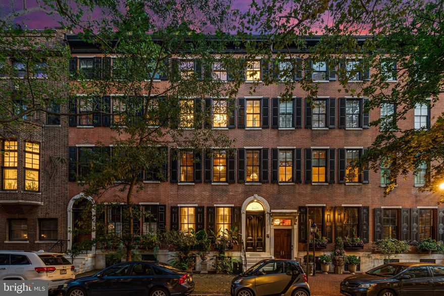 Welcome to 1828 Delancey Street, set on one of Philadelphia’s most coveted and picturesque residential blocks. This exceptional five-story townhome offers the extraordinarily rare convenience of a four-car garage—an amenity almost never found in this location—together with a complete redesign and rebuild completed in 2015, achieving a seamless balance of historic character and modern sophistication.

Encompassing approximately 5,580 square feet, including the finished lower level, the residence reflects extraordinary craftsmanship and a highly intentional level of design throughout. Every detail was considered, from the scale and flow of the living spaces to the exceptional materials and custom finishes. Among its most distinctive features is a state-of-the-art, 1,500-bottle wine cellar designed by David Spon.

The lower level is both functional and refined, featuring a fully equipped gym, powder room, the custom wine cellar, and direct access to the expansive four-car garage.

Designed for both large-scale entertaining and daily living, the main level offers an elegant front parlor and a beautifully executed gourmet kitchen by Conestoga, with tile design by Joanne Hudson. This space flows effortlessly into a sitting area and formal dining room, then opens to a thoughtfully designed outdoor deck complete with a built-in barbecue, dedicated dog area, and custom planters.

The second level is anchored by a sophisticated family room with a wet bar, stylish powder room, and access to a private deck. Also on this floor is a handsome office overlooking Delancey Street. Carefully pre-plumbed during construction, this room was designed to allow for an effortless conversion into an additional bedroom suite with a private full bath, adding flexibility to the home’s already impressive layout.

The third level is devoted entirely to the primary suite, offering a serene bedroom, spa-caliber marble bath, generous walk-in closet, dedicated vanity area, and a private terrace.

The fourth level includes two beautifully appointed guest suites, each with walk-in closets and en-suite baths, along with a second laundry area for added convenience.

Additional highlights include an elevator servicing every floor and a fully integrated Crestron smart home system controlling lighting, sound, HVAC, and security.

1828 Delancey Street presents a rare opportunity to own a turnkey, custom-built residence on one of Philadelphia’s most iconic historic streets.