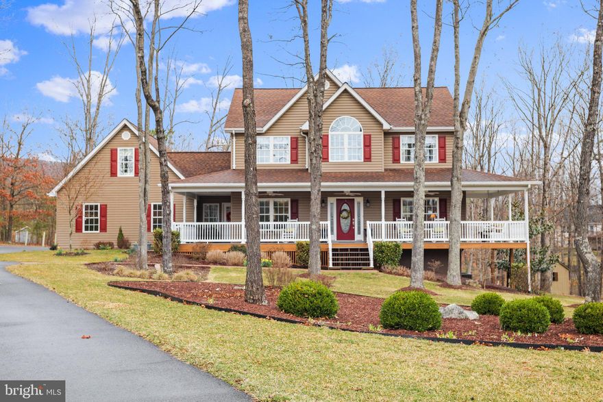 Located just South of Berkeley Springs in the prestigious Cacapon South community, this beautiful 4 BR, 4.5 BA Colonial oozes charm with multiple entertaining possibilities, beautiful landscaping, and quality care and construction. Tucked in the trees on a cul de sac, the paved driveway leads to a spacious parking area as well as a 2 car garage. Front sidewalks lead from the driveway to the covered wrap around front 
 porch, inviting you to an evening of relaxation. Main level features a cozy living room with gas fireplace, formal dining room, half bath, open kitchen, breakfast nook, family room and mud room leading to the
garage. There are gleaming wood floors throughout this level with access to a spacious rear deck and a screened porch. Upper level suite boasts an owner’s suite, 2 guest rooms and a guest bath. Bonus room over the garage has an outside entrance andcan be used as a fourth bedroom, craft/sewing room or a  studio. Lower level features two built in desk areas- perfect for working from home, additional family room with pellet stove, full bath and storage rooms. In addition the property includes a stone fire pit, storage shed for gardening tools and a stone walkway that meanders from the rear deck to the lower level French doors. Located just minutes from Cacapon Resort State Park for outdoor activities. Today, the park encompasses 6,115 acres and includes the 130-room lodge with restaurant, 50 year-round cabins, a 6-acre lake, picnic/shelter areas, and 27 miles of hiking trails. A riding stable is also on the property. The  Old Inn  houses twelve to fourteen people for reunions or special events There will be a new indoor/outdoor pool, a spa and fitness center, new public dining room, and updated kitchen. The Robert Trent Jones, Sr. designed golf course is considered one of the finest in the East, and will get upgrades. Voted USA Today’s Top 10 Best Small Southern Town in 2015, Berkeley Springs is a historic spa and art-filled town nestled in the West Virginia mountains only 90 minutes from the Washington/Baltimore metro area. It boasts warm mineral springs, world-class dining, blocks of distinctive shops, full-service spas and more than 100 lodging choices, from elegant B&Bs and historic inns, to cabins and resorts. Golf, hiking, biking and swimming share the schedule with year-round festivals, live music and theater. Friendly people, welcoming mountains and a sense of place mark Berkeley Springs as a getaway for all seasons and tastes