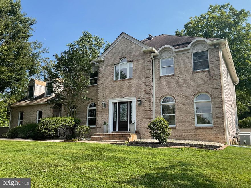 Majestically situated on a premium lot, this wonderful  "George Michael " built brick front colonial is the epitome of elegance and comfort. From its inviting curb appeal, to its rich interior, this home offers exceptional living. Step inside to discover features such as high ceilings, tons of natural light throughout, ample outdoor entertaining space with a sparkling pool; is move-in ready. Spacious formal living and dining rooms flank the front entry accented by a turned wooden staircase. The open and airy gathering room with its beautiful hardwood floors, vaulted ceiling, skylights and fireplace nested between French doors offers a lovely view of the backyard oasis and flows into a well-appointed kitchen. Sure to be the hub of the home, this chef’s kitchen is outfitted with a Wolf cooktop, double wall ovens, Sub Zero refrigerator, granite countertops and large island. The adjacent breakfast room is bathed in natural light from the wall of floor to ceiling windows, skylights and French doors leading out to the blue stone patio and free form pool. A first level in-law/au pair suite offers wonderful versality with an attached full bathroom, private side entry access and direct access to the patio and pool area. A half bath and mud room/laundry room complete the first floor. The primary bedroom suite is a true retreat with multiple closets, laundry chute, spacious sitting area, and a newly done luxurious en-suite bathroom featuring a double marble vanity, free standing tub and beautifully tiled open shower. Also on the second level are three other generously sized bedrooms, one with direct access to the hall bathroom outfitted with stylish new tile and dual vanities. Step outside to a lush, fenced rear yard boasting an expansive beautiful blue stone patio, sparkling blue pool positioned against a private wooded back drop, perfect for entertaining or simply relaxing in your private outdoor oasis. Other desirable features include generator and an unfinished lower level which provides for ample storage and potential additional finished space. This exceptional property is located in the Council Rock School District with easy access to I-295, train stations for commuting to NYC, Philadelphia, or Princeton, and local amenities in Newtown and New Hope for shopping and dining. This is a special location that provides a neighborhood environment but offers the privacy of a 4.8 acre lot. Don't miss the opportunity to make this exquisite home your own!