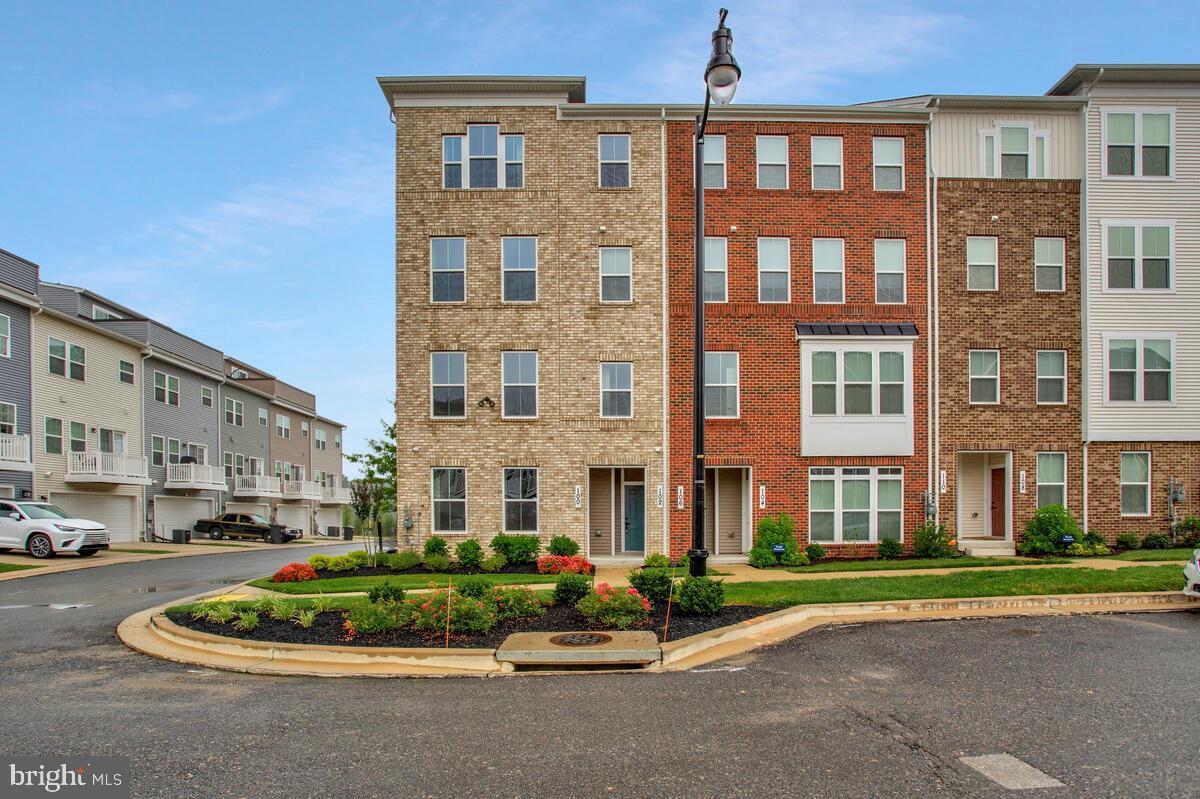 Step into luxury living with this brand new 3-bedroom, 2.5-bath townhouse/condo! Featuring 9’ ceilings and an open-concept layout, this home is designed for modern comfort and style. The main level is flooded with natural light and includes a gourmet kitchen with quartz countertops, a large island, stainless steel appliances, and a beautiful tile backsplash. Enjoy meals in the dedicated dining area, unwind in the spacious great room, or step out onto the balcony for fresh air and relaxation next to the gas fireplace. A convenient powder room completes this level. Upstairs, you’ll find three generously sized bedrooms, each with its own walk-in closet and cozy wall-to-wall carpeting. The primary suite boasts a tray ceiling, sitting area, two large closets, and a spa-like bathroom featuring a dual vanity, walk-in shower with built-in bench, and elegant finishes. The second full bathroom also offers a dual vanity, tub/shower combo, and plenty of natural light. Enjoy the convenience of an upper-level laundry room with a full-size stacked washer and dryer, built-in cabinets, and a quartz folding counter. The home also includes a rear-entry garage and private driveway for easy parking. The South Lake neighborhood's current amenities include a clubhouse, fitness center, aerobics room, and pool. Additional amenities to be added in the near future, please visit South Lake's community website for more details. Located only 40 minutes away from Washington D.C. and 30 minutes from Annapolis! Don’t miss your chance to call this beautiful space home!