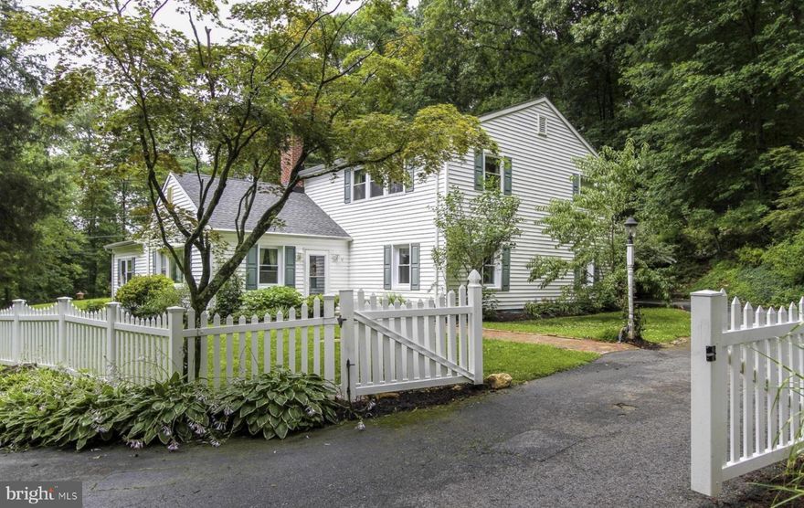 Set on a private, wooded one acre lot in Phoenix, this home feels like a retreat where days slow down and moments matter. Imagine gathering friends around the dining table for candlelit dinners, laughter carrying from the kitchen as meals are prepared and shared. The oversized kitchen, with abundant hickory cabinetry and a Sub Zero refrigerator, is made for holidays and long weekends, with space for cooking together, setting out platters, and lingering long after the dishes are cleared.

Multiple living spaces invite different ways to unwind. A large family room centers around a wood stove, perfect for cozy evenings, while a separate living room with a working wood burning fireplace offers a quieter place to relax. Two bedrooms and a full bath on the main level provide flexibility for guests, work from home space, or easy one level living. A formal dining room and a more casual dining area allow the home to adapt beautifully to both everyday life and special occasions.

Upstairs, the entire second floor is devoted to an expansive primary suite that feels almost treehouse like. French doors open to a rear deck, and a catwalk leads down into the landscaped yard, creating a magical connection to the outdoors. Outside, the grounds invite a lifestyle centered on nature, with a pond and waterfall, space for a beautiful flower or vegetable garden along the side yard, and two outbuildings offering endless possibilities for a workshop, studio, or creative retreat. A large carport adds everyday convenience.

Solar panels enhance the home’s efficiency and provide the opportunity to purchase electricity back from the solar company at a deeply discounted cost, helping to keep utility expenses lower while supporting a more sustainable lifestyle. With a new roof in 2024, updated flooring in the kitchen, bathrooms, and sunroom, a rebuilt pond, and major systems and appliances thoughtfully updated over time, this is a home that offers privacy, character, and a way of living that feels both intentional and relaxed.