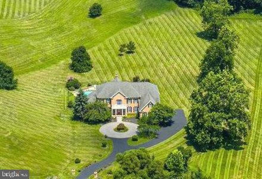 An AMAZING GRAND ESTATE HOME & PRICE!! Gorgeous Rare Royal Circular Driveway "#1", Magnificent Grand Double Staircase "#2",  Memorable Blue Horizon Heated Swimming Pool with Waterfall, Tanning Platform, Brick & Stone Patio & a Gas Fire Pit "#3" ... All 3 of these Amazing Features IN ONE HOME & for Under $2.100,000!!! All for Fun & Joyful Grilling & Entertaining!! This Unique Grand Estate Home with a Multitude of Prestigeous Features ALL IN ONE HOME & Overlooking 3.28 Acres!!! The Double Brick Post Entry onto the Beautiful Drive & Stroll into this Grand Estate Home Features an Enhanced High-Quality Tile, 4 Faux Marble Columns & an Exquisite Foyer Authentic Crystal Chandelier plus a 20+ Ft. Ceiling ... Let the Excitement Begin!!  Radiant Dining Room Hardwood Floors, Remarkable Family Room Also with 20+ Ceiling, Spectacular Masonry Fireplace & a 14 Ft. Mantle to Ceiling Mirror Adorns this Memorable Living Environ!! And as You look to Your Right You Gaze Upon the Wonderful & Elegant Dining Room with A Special Trey Faux Marble Ceiling & a 2nd Authentic Crystal Chandelier!!! More Viewing Adventure as You Approach the CHEFS Gourmet Kitchen with Granite Counter Tops, Ornate Wood Cabinets, Lavish Granite Kitchen Island plus a 3rd Authentic Crystal Chandelier In the Breakfast Area &  Stainless Steel Appliances!!!  Enjoy this Amazing Multi Interior View All from the Entry Foyer!!! This Grand Estate Magic Will Keep You Happy, Revitalized & Relaxed!! 4 Bedrooms, 4 Full Bathrooms, 4 Walk In Closets, 3 Car Side Load Garages!!  2 Tremendous Open & Airy SUNROOMS Encourage You to RE-ENERGIZE Yourself Each & Every Day plus an Upscale Office/Den with Exceptional Wood Bookcases & Stunning Floors!!! Replaced Radiant & Exquisite Hardwood Floors Throughout the Upstairs 2nd Floor along with a Captains Perch Overlooking the Family Room & Foyer plus a 3rd Staircase that leads to the Family Room & Kitchen too!! A Superior Master Bedroom with 2 Columns, Sitting Room, Extravagant Hardwood Floors, 2 Walk In Closets, 2 Separate Sinks, Soaking Tub with Jets!! And a Replaced Classy & Separate Shower adds to this Already Friendly & Glowing Home!! 8 Impressive Ceiling Fans throughout this Fantastic Home & 2 of them are Very Unique Paddle Fans!! Exceptional High Level of Workmanship Highlight the Brick Quoining on the Exterior of this Top-of-The-Line Estate Home plus 7 Hi-Tech Exterior Security Cameras & the Entire Interior Boasts A Full Hi-Quality Sound System Plus Built In Speakers!! Beautiful Landscaping plus An Impressive Regal Circular Driveway Awaits You Each Morning & Evening as You Access Your Majestic Environ!! Only Moments Away from Your Front Door is Old Town Leesburg with many Jolly & Enjoyable Restaurants-Bars, Shops & Joyous Activities!!  Leesburg's Executive Airport is right around the corner & Dulles International Airport is 20 minutes down Route 28!!! An easy ride to Tysons Corner, ONE Loudoun & Winchester all on Route 7!! A Day or A Weekend at Charles Town Raceway is a quick drive-up nearby Route 15!! Virginia Vineyards & Craft Beer Breweries are all around you to Enjoy on those Delightful Times when You, Family & Friends want to Imbibe & Celebrate an Outstanding Event or just share a Hospitable & Happy Fun Time!!! COME & EXPERIENCE THIS RARE, UNIQUE & ONE OF A KIND ARRAY OF THE MOST IMPRESSIVE FEATURES ON THE MARKET FOR SALE!! And the Best part of Owning this Grand Estate Home is You do not need to over pay for a 6 or 7 bedroom house and You do not need to over buy for a finished basement that You do not need in order to get All of The Amazing Luxuries that this EXQUISITE HOME Has Now!!! BUY NOW ... ENJOY NOW ... GROW LATER when You need the extra space!!! And if You do You can Create EXACTLY the basement features You Want!!!