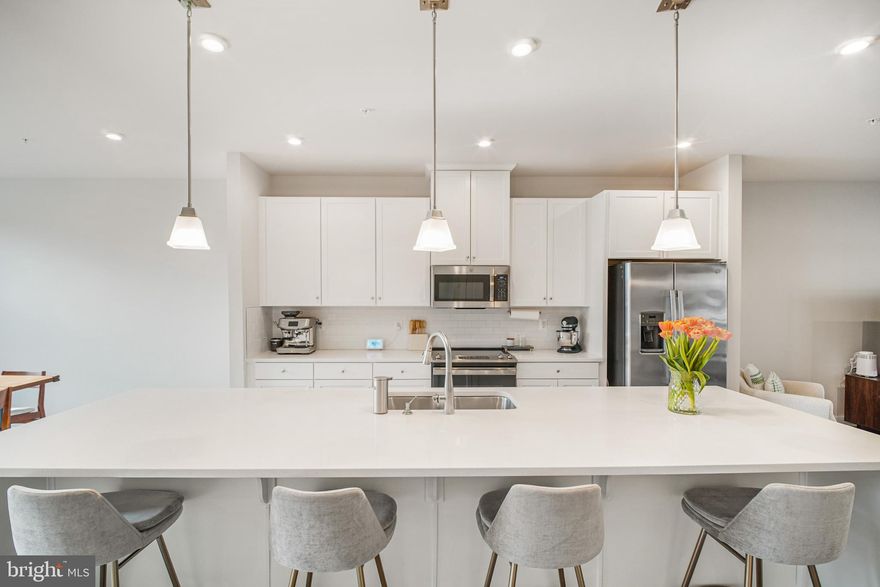 **Elementary School has been rezoned to Floris Elementary (6/10 on Great Schools).  Please check Fairfax County School to confirm.

Nearly 2,500 square feet across two spacious levels -- this upper-level condo in Foster’s Glen lives like a townhome while giving you the simplicity of low-maintenance ownership.

From the moment you walk in, the scale stands out. The open-concept main level was designed for real life: easy mornings, relaxed evenings, and seamless entertaining. The kitchen anchors the space with a large island that naturally becomes the go-to gathering spot. Stainless steel appliances, generous cabinetry, quartz countertops make it as functional as it is stylish.

The adjoining living and dining areas flow together with room to breathe. There’s flexibility here - configure the space for cozy movie nights, a full dining setup, or a work-from-home zone without sacrificing comfort. You'll also find a spacious covered balcony with a built in gas fireplace with year round enjoyment. Built just about four years ago, everything feels clean, modern, and move-in ready. No projects. No updates waiting in the wings. Just unpack and enjoy.

Upstairs, oversized bedrooms continue the theme of generous proportions.  The primary bedroom comes with two walk in closets and an ensuite bathroom with double vanities and a walk-in shower. 

Practical perks make daily life easier. A one-car garage plus driveway provides convenience and extra storage—an uncommon bonus in many condo communities. And with condo fees covering water, sewer, trash, snow removal, landscaping and common area maintenance, ownership stays refreshingly straightforward.

Beyond your front door, Foster’s Glen offers a lifestyle that feels active yet manageable. Scenic walking trails with outdoor fitness stations weave through the community, along with playgrounds and a picnic pavilion that invite you to get outside and connect.

Location ties it all together. You’re just minutes from the Silver Line Metro and major commuter routes, making travel across Northern Virginia and into D.C. smooth and efficient. Washington Dulles International Airport is conveniently close for work trips or weekend escapes. And throughout Herndon and nearby destinations, you’ll find a vibrant mix of shopping, dining, and entertainment options.

Spacious, nearly new, thoughtfully designed, and exceptionally located -- this is the kind of home that gives you room to grow without adding complexity to your life. If you’ve been waiting for space, style, and value to align, this is your opportunity.

**Elementary School has been rezoned to Floris Elementary (6/10 on Great Schools).  Please check Fairfax County School to confirm.