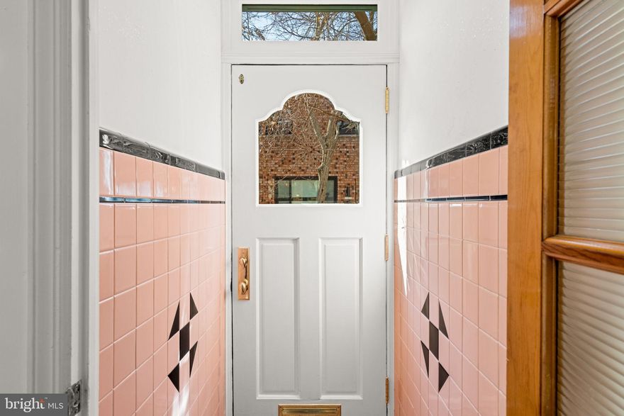 Welcome to 1607 S Beulah St - the kind of classic South Philly home that rarely comes along. Tucked on a quiet tree-lined one-lane street, this block feels like a hidden gem just moments from the energy of East Passyunk. The charm starts before you even walk inside. A green Tofani front door, wrought iron porch surround, and tiled landing create the perfect first impression. Step into the vestibule featuring pink and black tiled walls and floor, plus a beautiful 5-panel interior door with reeded glass. Inside, the open living and dining space is bright and inviting, anchored by an oversized front window that fills the room with warm afternoon light. It flows right into the spacious kitchen, complete with slate floors, white cabinetry, butcher block counters, under-cabinet lighting, stainless steel appliances, and a large window that keeps the space feeling light and airy. There’s plenty of room to create an eat-in kitchen setup - a pendant light is already in place for your table - or add an island if that’s more your style. Out back, the private patio is ready for morning coffee, container gardening, or hosting friends for a summer hang. Upstairs you’ll find three generously sized bedrooms, each with closets,  wide plank red and white pine hardwood floors, and original doors featuring vintage crystal knobs. The middle bedroom includes built-in shelving and a cedar-lined closet. The full bath was updated in 2022, a stunning renovation featuring modern white tile wrapping the walls, a tub/shower combo, custom vanity with a concrete sink, gold fixtures and accents, and heated floors for a little everyday luxury. Additional updates include wood-framed windows which were replaced in 2017, adding warmth throughout the home, with several featuring beautiful white marble sills. The unfinished basement offers great storage, complete with a built-in closet, some very cool vintage cabinetry, and a washer and dryer. And the location? Hard to beat. You’re just minutes from neighborhood favorites including Cosmi’s Deli, Termini Brothers Bakery, Fountain Porter, Rival Bros Coffee, El Chingón, The Jim, and many more along East Passyunk Ave. Move-in ready, full of original character, and perfectly located in a highly walkable area. Just bring your things and start enjoying South Philly living.
