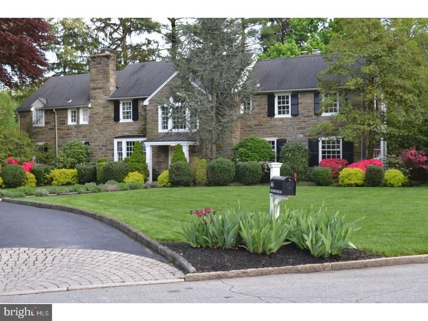 This stately stone colonial with a contemporary flair interior is set on one of the most coveted Northside Wynnewood streets. From the bright formal living room with its deep seated windows and an ecosmart fireplace to the adjacent family room addition with original exposed stone wall and wet bar including two integrated refrigerated drawers and a sink, this home is truly a blend of classic details and functional, modern design.  Enter the 2 story foyer with its grand wrap around staircase and original wide plank flooring and be welcomed into the large formal dining room with its original moldings, french doors and a picturesque window overlooking the rear yard. The updated kitchen featuring natural cherry beaded inset cabinetry, a large island with counter seating, stainless appliances, granite counters, and slate flooring. An exposed stone wall, vaulted ceiling and abundance of windows make for a bright breakfast area and a welcoming place to enjoy the backyard views. A new powder room and a separate office with built in shelving and charming stone beehive fireplace complete the first floor.  Upstairs find a spacious master bedroom suite with tray ceiling, 2 custom built in closets and a full bath with double sinks, jacuzzi tub and walk in shower, as well as four additional nice size bedrooms each with new private baths (one jack and jill and 2 ensuite) as well as a back stairway that leads to the kitchen.  A fantastic finished lower level (not included in square footage)provides a wonderful play/game room, a new laundry room/gym area, half bath and temperature controlled wine cellar.  Enjoy evenings outside relaxing on the custom stone patio surrounded by professionally landscaped grounds, a sprawling yard and perennial plantings.  This home has been meticulously maintained-new gas furnace (2014), new air conditioning unit (2014), newer hot water heater (2013), stereo surround in many rooms and an in ground sprinkler system.  Walk to downtown Narberth,  playgrounds and fields are across the street, minutes to the R5 train, and easy commute to Center City. Plus choice high school zone- you pick Lower Merion High School or Harriton.  Main Line luxury with low taxes in a most desirable neighborhood.