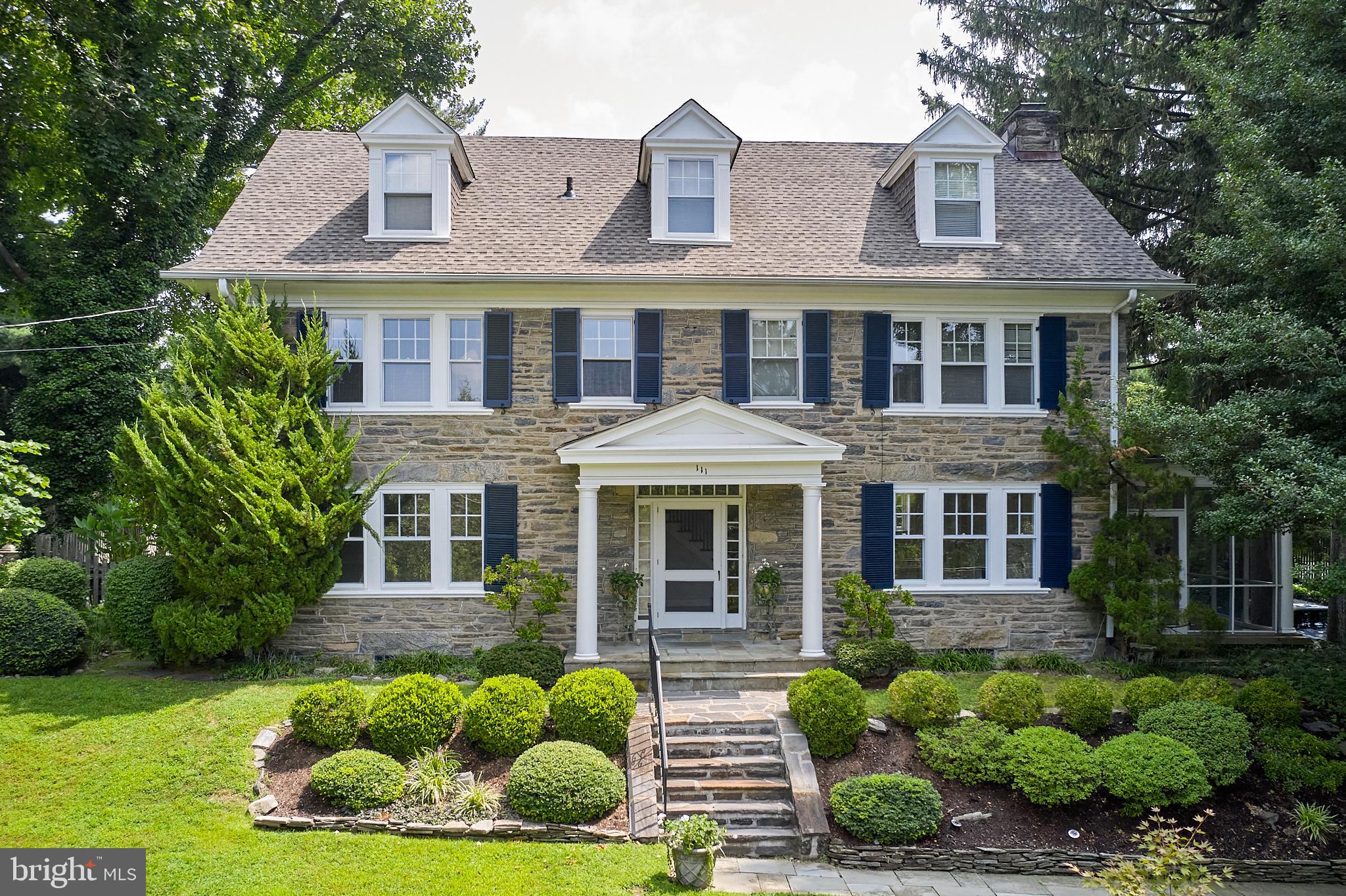 Welcome to 111 Saint Georges Road, an elegant and timeless center hall, 3-story, stone colonial nestled in the heart of Ardmore, Pennsylvania. This exquisite residence boasts 5 bedrooms, 3.5 bathrooms, and 4,014 above-ground (+ 1,494 below-ground) square feet of living space, all on a generous lot spanning .42 acres with lovely, perennial flower beds watered automatically by an eight-zone sprinkler system. As you step inside, you'll be greeted by the majesty of large, oversized windows that flood each room with natural light, illuminating the beautiful wood floors and highlighting the meticulous attention to detail in the millwork throughout the home. The living room features a captivating gas-burning fireplace, while an adjacent high-ceiling screened-in porch offers a serene retreat for relaxation and entertainment. The home's all ceramic-tile bathrooms and main bathroom with heated floor exemplify the commitment to luxury and comfort. The wonderful, expanded kitchen, with gas cooking and an attached breakfast room, provides a picturesque view of the expansive backyard, creating a perfect setting for everyday dining. Step outside to discover the allure of the inground pool with Polaris self-cleaner, surrounded by a flat backyard with mature plantings that offer maximum privacy. A brick terrace with water features of waterlilies provides an ideal outdoor entertainment and relaxation space. The basement provides two egresses, one to the garage and the outside, and offers possibly additional areas for family and friends’ activities. This remarkable property ensures functionality and ease of living for the discerning homeowner. With its timeless charm, luxurious amenities, and thoughtful design, 111 Saint Georges Road presents an unparalleled opportunity to experience the epitome of gracious living in Ardmore. Couple all this with its proximity to Ardmore’s Amtrak (easily connects NYC) & Septa transportation, and Suburban Square, with its convenient shopping and entertainment, and great schools (located in “option zone”), you have, simply, a must-see!