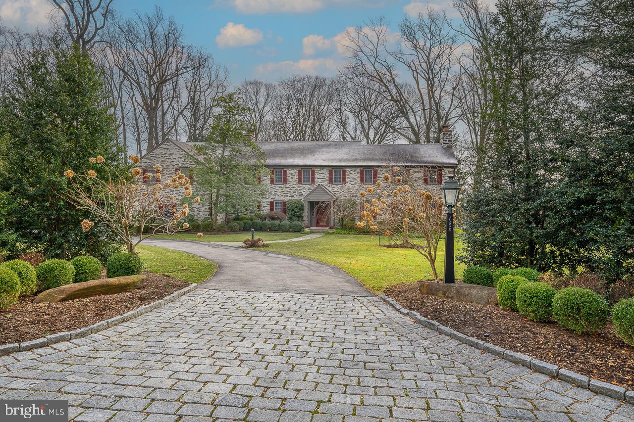 Elegant and impeccably maintained stone colonial on prestigious street features 5/6 bedrooms and 4.5 baths. Designed by the renowned firm of Henry D Dagit & Sons, this classic home offers the hallmarks of gracious, yet comfortable, Main Line living surrounded by 1.39 acres of professionally landscaped grounds. Entrance hall flanked by arched passage ways leads you one way to a cozy den with built in bookshelves and French doors to patio, formal Dining Room with marble fireplace and another set of French doors to patio. Updated eat in gourmet Kitchen including custom Heritage cabinetry, new double Wolf oven, warming drawer, two Bosch dishwashers, 6 burner Viking range with pot filler, two refrigerator drawers, two sinks and built in Viking refrigerator. Convenient inside access to Garage. To the right of entrance is a formal Living Room featuring a fireplace with marble surround and double set of French doors leading to bilevel Family Room with brick fireplace, oversized windows and transoms, reclaimed barn wood beams, posts and accents, herringbone wood floor and door to outside. Coat Closet and Powder Room complete this level. On the second floor you will find the Main Bedroom addition including two sitting areas, wall of closets and en suite Bathroom. Adjacent is another new Bathroom with custom zebra wood vanity and access to walk in Closet/Dressing room (easily converted back to 6th Bedroom/laundry room/office) and additional Bedroom with marble fireplace. Continue down the hallway to two additional Bedrooms with adjoining new Bathroom, 5th bedroom and Bath at top of back stairs (perfect for in law or au pair). Floored attic with cedar closet provides additional storage. Two sets of stairs lead to a finished portion of the Basement with fireplace as well as storage, newer heater, hot water heaters, washer and dryer. Need some time to yourself? Don't miss the fun bonus structure outside the kitchen door which would make a perfect she shed, man cave, office, gym or art studio! Generac generator, newer Anderson windows, brand-new high-quality 7/8" cedar shake roof, new Hardie Board siding on addition and out building. This home is ready to move in. Minutes to Rts 76 and 476 as well as Gladwyne, Bryn Mawr and Villanova.