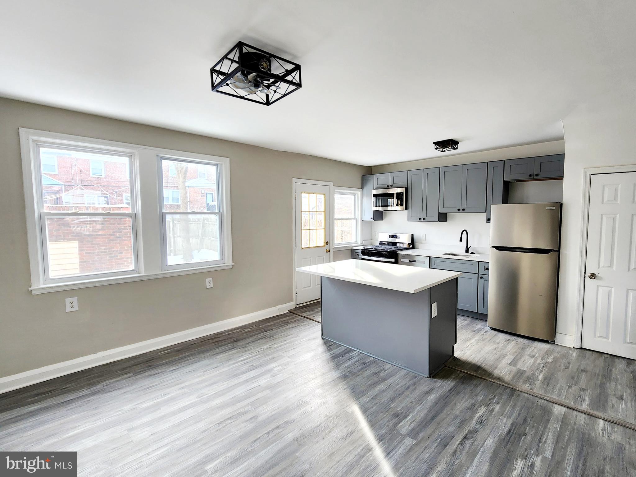 This beautiful 3-bedroom, 2-bathroom townhouse has been completely updated . With its modern upgrades and prime location, this home is perfect for those looking for comfort and convenience.
As you approach the house, you’ll be greeted by a charming front porch, perfect for relaxing after a long day. The exterior boasts new, easy-to-care-for landscaping and a stylish new light fixture, adding to the home’s curb appeal.
The main level offers a spacious living room that flows seamlessly into the dining room and kitchen, creating an open and inviting space. The dining room features a ceiling fan with an integrated light, both of which can be conveniently controlled by a remote. The fully renovated kitchen showcases new quartz countertops, sleek cabinets, and a stylish island for extra prep space. Brand-new stainless steel appliances, including a stove/oven, refrigerator, microwave, dishwasher, and garbage disposal, complete the kitchen. Luxury vinyl (LV) flooring has been installed throughout the first floor for a polished, cohesive look.
Upstairs, the second floor features three freshly painted bedrooms in a modern natural gray palette. Each bedroom is equipped with a ceiling fan that also functions as a light, both of which can be controlled by a remote for added convenience. The updated bathroom on this level boasts a new vanity, new toilet, updated lighting, and fresh modern paint. The hallway provides access to a pull-down attic for additional storage, and new LV flooring runs throughout the second floor for a sleek, contemporary finish.
The basement offers even more living space with a cozy den featuring plush new carpeting and fresh paint. At the back of the basement, you’ll find a large storage area with washer/dryer hookups and new LV flooring. The additional full bathroom in the basement is completely updated, featuring a new toilet, new vanity, new sink, and a beautifully tiled shower. The basement has a walkout to a private backyard, which includes a garage with a brand-new roof for added functionality.
This home also features significant system updates, including a brand-new central air unit, ensuring year-round comfort.
Located within walking distance of Morgan State University and close to Lake Montebello and Johns Hopkins University, this home offers both convenience and charm. With its modern upgrades, easy-to-maintain landscaping, and prime location, this house is truly move-in ready.