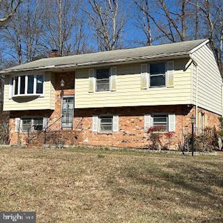 Great Investment Opportunity! This split-foyer home, situated on a spacious corner lot, offers incredible potential. Featuring 4 bedrooms and 2.5 bathrooms, this home boasts an efficient layout, a wood-burning fireplace, and both a deck and patio for outdoor enjoyment. The large basement includes a laundry area and ample storage space.  With two off-street driveways, parking is never an issue. Conveniently located near I-95, shopping, and dining, this property is perfect for investors or buyers looking to add their own personal touches. Don’t miss out on this fantastic opportunity—schedule your showing today!
