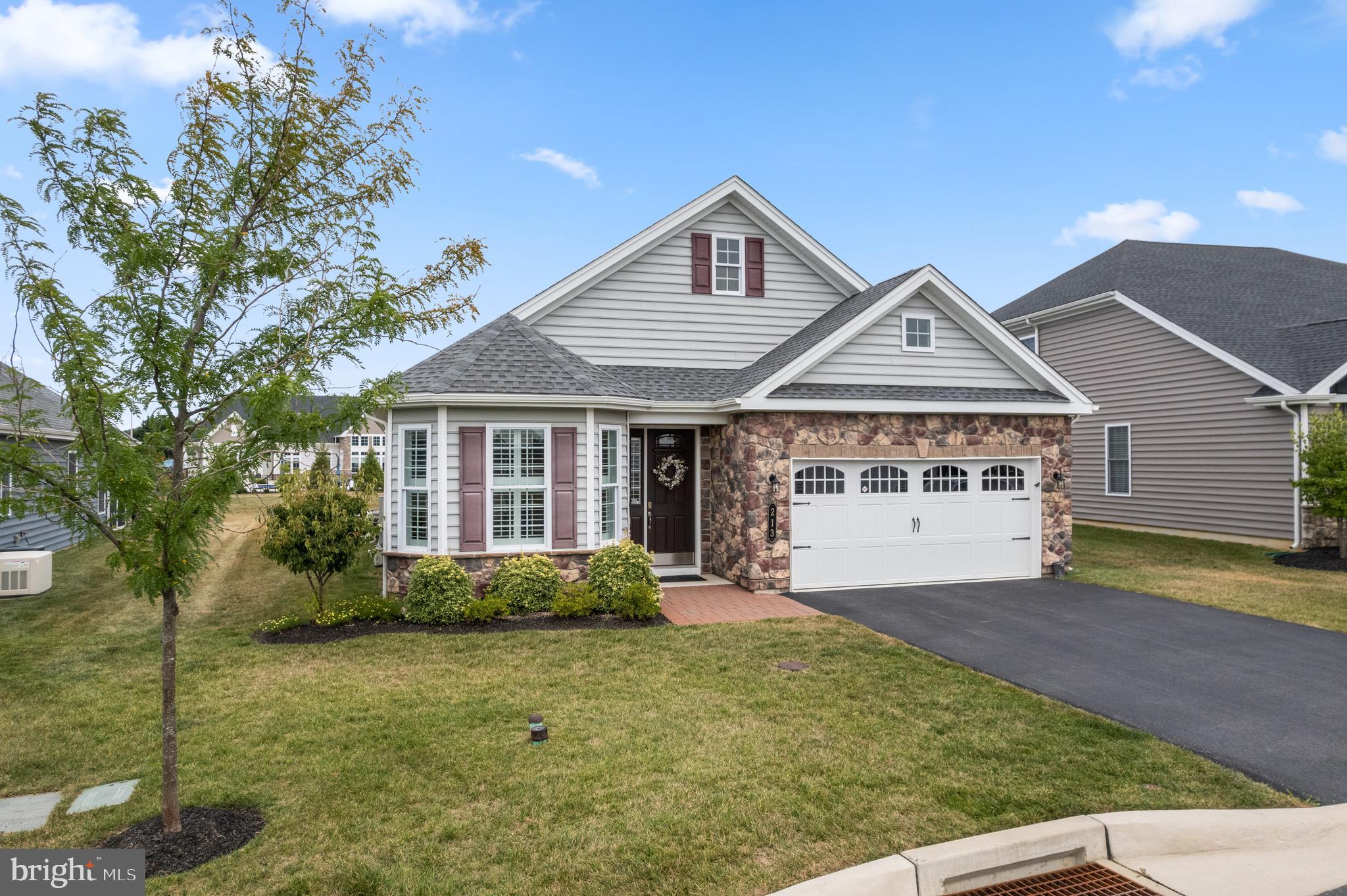 Welcome to 213 Resolution Drive. A meticulously maintained home in the premier 55+ community, Traditions of America at West Brandywine. Nestled in the heart of Chester County’s sought-after active adult community, this beautifully appointed residence offers an exceptional blend of comfort, style, and low-maintenance living. Built just five years ago, this move-in ready home showcases luxury upgrades throughout with functional design. The main level features an open-concept great room filled with lots of natural light, complemented by custom plantation shutters throughout the home. The great room and primary bedroom both were built out with 2' extensions for additional space. A cozy gas fireplace in the great room is perfect for everyday living. The gourmet kitchen is a chef’s dream, complete with a convenient cooktop, soft-close cabinetry, pull-out shelving, and an oversized island ideal for entertaining. Adjacent to the kitchen, the formal dining area provides a welcoming space for hosting family and friends. A bright and inviting sitting room offers a quiet retreat for reading or relaxing, while the spacious guest bedroom and full hall bath provide comfortable accommodation for visitors. The primary suite is a true sanctuary, highlighted by a tray ceiling, two custom walk-in closets, and a spa-inspired bath featuring a walk-in shower, double vanity, and linen closet. Main-level laundry room adds everyday convenience. Upstairs, a fully drywalled unfinished area offers flexible potential for additional living space or expansive storage. Residents of Traditions of America enjoy access to an impressive array of resort-style amenities at the community’s state-of-the-art clubhouse, including a heated outdoor pool, hot tub, Yoga/Pilates studio, fitness center, golf simulator, theater room, pickleball courts, entertainment spaces, and scenic walking trails. Ideally located just minutes from Exton, West Chester, King of Prussia, dining, and shopping destinations. Don’t miss this opportunity to enjoy the best in active adult living — schedule your private tour today!