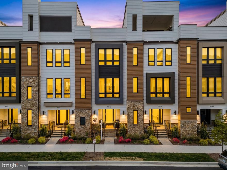 Welcome to luxury living at its finest in this nearly new, impeccably designed townhome in one of Rockville’s most sought-after communities, The Grove. Built in 2024 by award-winning Wormald Homes, this sophisticated residence blends thoughtful architecture, high-end finishes, and abundant natural light—delivering a lifestyle that feels both elevated and effortless.

Inside, soaring 10+ foot ceilings and wide-plank flooring set the tone for the main level, where open-concept living and dining spaces flow seamlessly. Floor-to-ceiling Sierra Pacific windows, finished in striking black, flood the home with natural light while adding a bold, modern edge. Just off the main living area, a private lanai offers the perfect setting for morning coffee or evening cocktails.

The gourmet kitchen is designed to impress, featuring premium Bosch appliances, upgraded cabinetry, sleek countertops, and an oversized quartz island that anchors the space. A custom-built bar enhances both functionality and style—ideal for entertaining or everyday living.

The entry level offers a versatile flex space perfect for a home office, gym, or guest suite, along with a powder room, mudroom, and access to a two-car garage. Upstairs, the primary suite provides a peaceful retreat with dual closets and a spa-inspired en-suite bath. Two additional bedrooms, a full bath, and a spacious laundry area complete the upper level.

Each level of the home offers its own unique space to relax and recharge, from private outdoor areas to thoughtfully designed interiors—creating a seamless balance of comfort and connection throughout.

Located in the highly regarded Wootton School District, residents enjoy access to exceptional community amenities, including a clubhouse with a gym and pool, walking trails, sports fields, playground, and dog park. You’re just minutes from shopping, dining, and entertainment at Traville Gateway, Fallsgrove, Downtown Crown, Rio, and Kentlands, with convenient access to I-270, the BioMed Corridor, Shady Grove Hospital, AstraZeneca, and the Shady Grove Metro.

Move-in ready and better than new, this home offers the rare opportunity to enjoy modern luxury without the wait. Just unpack and start living.
Mortgage savings may be available for buyers of this listing.