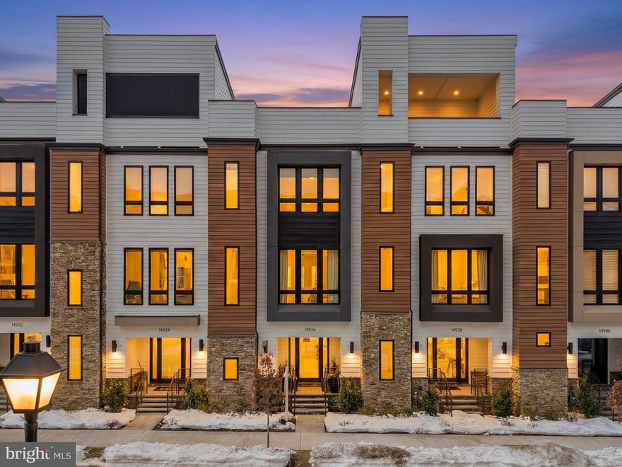 Welcome to 14936 Dispatch Street, a refined, light-filled 3-level townhome in the heart of The Grove, built by Wormald Homes in 2024. This like-new residence is better than new, featuring designer upgrades rarely found on the resale market.
Wide-plank flooring, 10+ ft ceilings, and abundant natural light create the feel of a single-family home with the ease of townhome living. The entry level offers a versatile flex space ideal for a home office, gym, or guest area, plus a powder room, mudroom, and access to a two-car garage.

The gourmet kitchen features upgraded countertops, 42” cabinetry, premium Bosch appliances, an oversized island, and a custom-built bar—perfect for entertaining. The open-concept living and dining areas are anchored by a cozy gas fireplace and open to a private balcony for grilling or relaxing.

Upstairs, the primary suite includes dual closets and a luxurious en-suite bath. Two additional bedrooms, a full bath, and a spacious laundry area complete the upper level.

Move-in ready with no waiting. Community amenities include a pool, clubhouse with gym, soccer field, dog park, and walking trails. Minutes to Trader Joe’s, Downtown Crown, Rio, Kentlands, major fitness centers, Johns Hopkins, and Shady Grove Hospital.
Mortgage savings may be available for buyers of this listing.