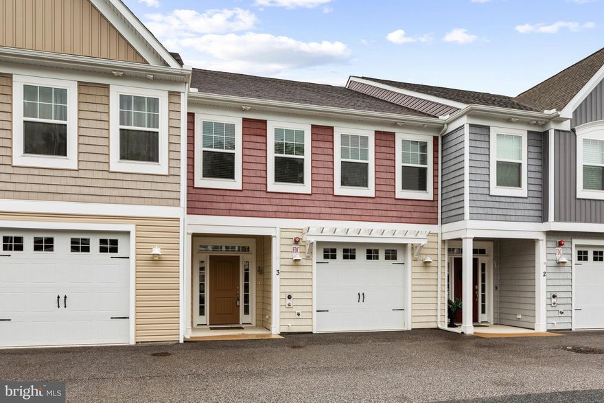This four-bedroom, three-story townhouse offers significantly more space than its exterior suggests. As you enter the bright foyer, you're welcomed by stylish LVP flooring that flows seamlessly into the expansive open-concept main living area. This combined space includes a dining room, living room, and a well-appointed kitchen.

The kitchen features 42-inch wood cabinets, granite countertops, and stainless steel appliances, including a double sink with a gooseneck pull-out faucet. Warm, inviting tones make it the heart of the home. Just off the kitchen, a cozy breakfast nook opens through sliding glass doors to the back patio, perfect for outdoor dining or relaxing.
The first floor also includes a spacious utility closet with a utility sink, a convenient powder room, garage access, and a coat closet for added functionality.

Upstairs, the second floor hosts a remarkably large primary bedroom with tranquil views of the surrounding trees. This serene retreat boasts two walk-in closets and a spa-like en suite with beautiful tile flooring, an open walk-in tiled shower, private water closet, dual vanity, and a linen closet.
Two additional well-sized bedrooms, each with walk-in closets, a full hall bath, and a spacious laundry room complete the second floor.
On the third floor, a second expansive primary suite awaits. It features recessed lighting, a large walk-in closet, and its own full bath, making it a perfect guest suite, private getaway, or flexible family/media room.

Enjoy an unbeatable lifestyle with community amenities that include a sparkling inground pool with a pool house, a tot lot, and a basketball court, ideal for staying active or socializing with neighbors.

This exceptional home is ideally located near Bethany Beach, Ocean City, and several state parks and wildlife areas, offering the perfect blend of coastal living and natural beauty. Whether you’re looking for a primary residence or a vacation escape, this home delivers space, style, and a vibrant community setting.