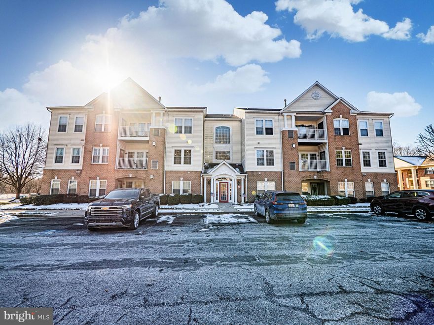 Completely updated ground-floor condo located in The Courtyards at Pond, one of Forest Hill’s premier condominium communities. This sun-filled residence offers both front and rear private access, including a peaceful patio ideal for relaxing or entertaining. Upon entry, a welcoming foyer showcases luxury vinyl plank flooring, a convenient coat closet, and an additional storage closet. Modern, updated light fixtures are featured throughout the home, adding a sleek and contemporary touch. The open-concept dining and family room is highlighted by thick plush carpeting, a portable gas stove, and large windows that flood the space with natural light. The gourmet kitchen is beautifully appointed with LVP flooring, granite countertops, custom wood cabinetry, stylish tile backsplash, and a pantry for added storage. Just off the kitchen, a cozy breakfast nook provides a walk-out to the rear patio overlooking the community, perfect for morning coffee or evening unwinding. The oversized primary bedroom features designer carpeting, a spacious walk-in closet, plus an additional mirrored closet. The luxury en-suite spa bathroom includes a dual-sink stone vanity, frameless glass shower with tiled walls, built-in sitting bench, grab rails, and a rainfall showerhead. A generously sized secondary bedroom is situated on the opposite side of the home for added privacy and offers ample closet space. It is complemented by a modern hallway bathroom with LVP flooring, stone-top vanity, and a tub/shower combination. Enjoy close proximity to shopping, dining, and commuter lots, making this home both convenient and move-in ready.